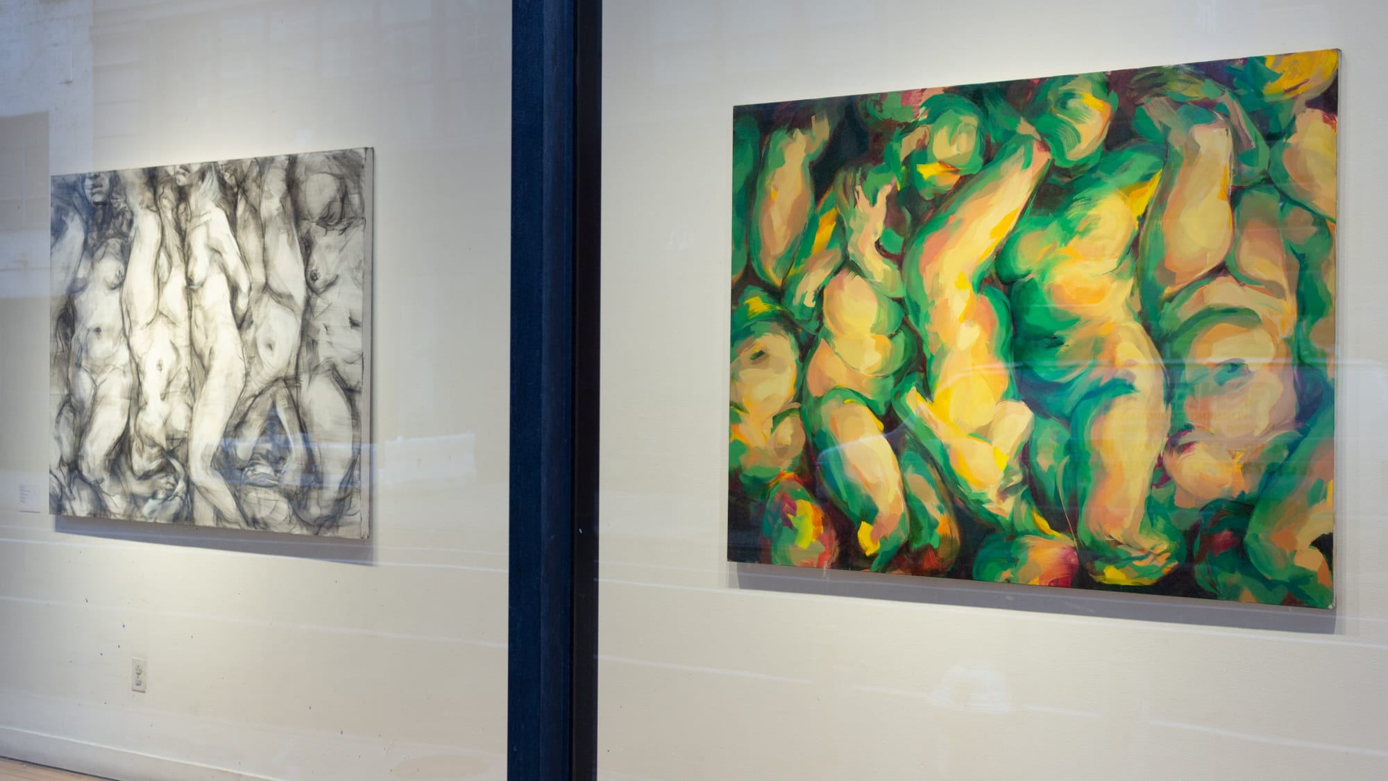 Photograph from outside SVA Flatiron Gallery looking in through windows, with two abstract paintings of fleshy bodies on display.