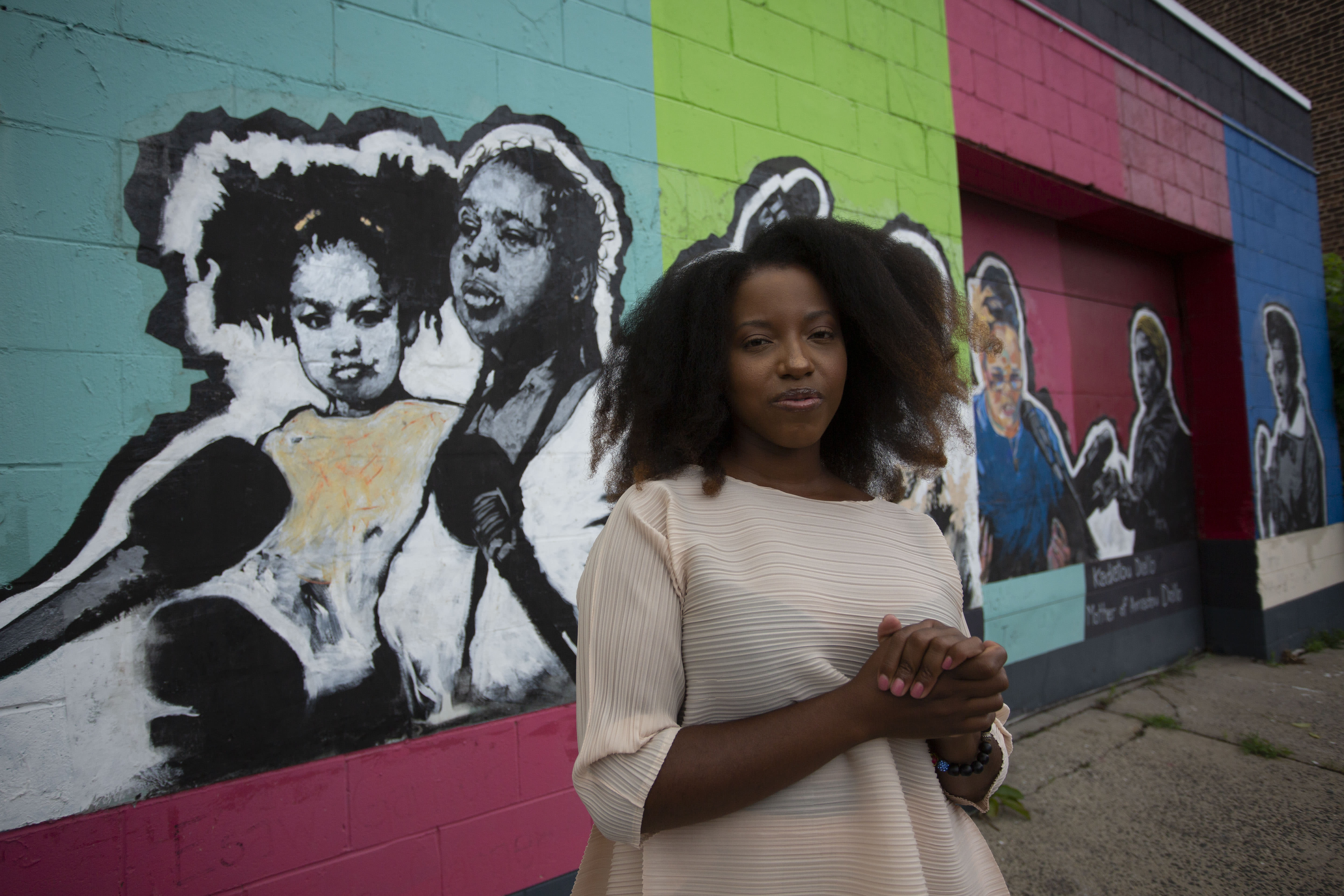 Image of Sophia Dawson standing in front of a mural