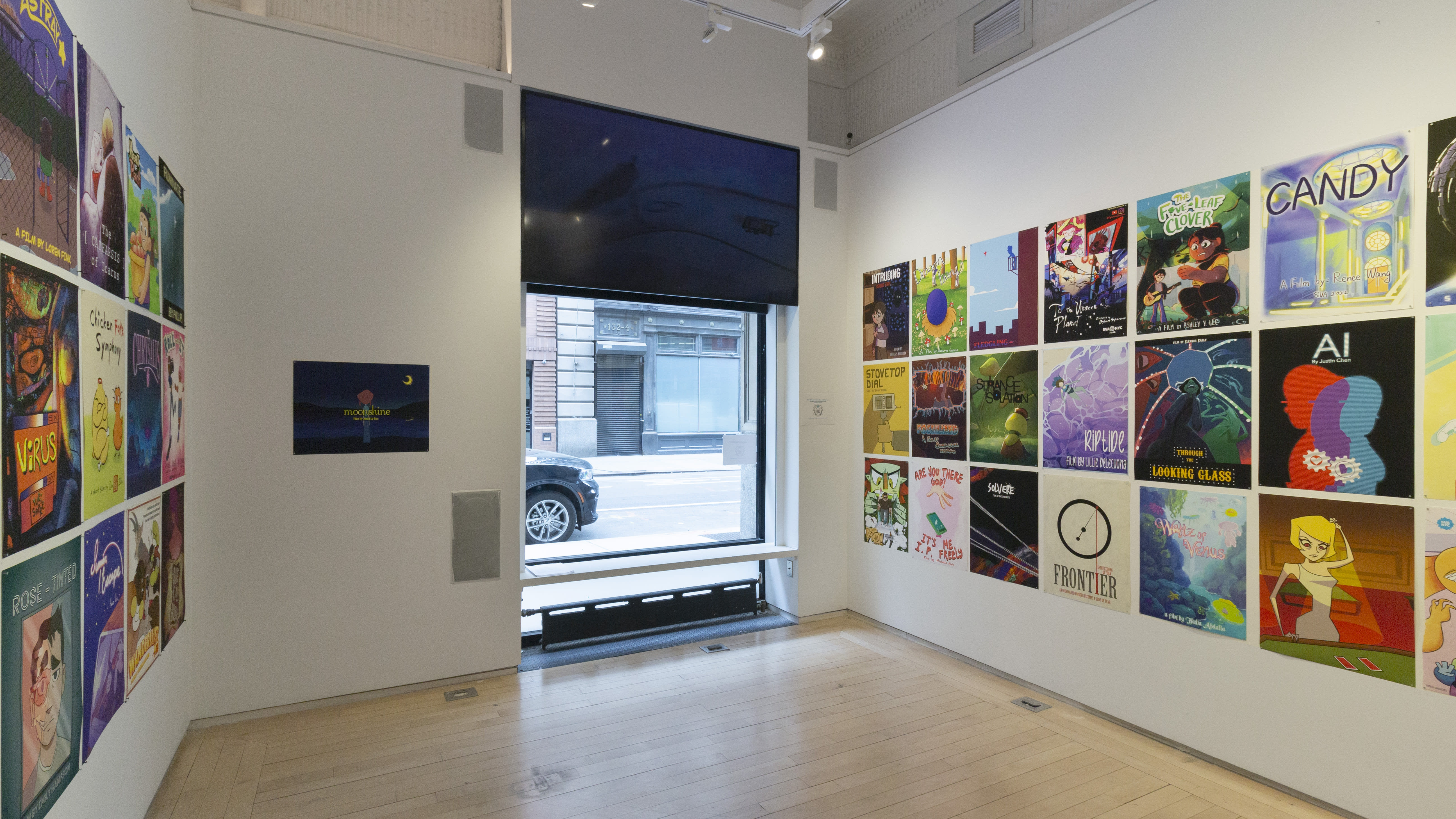 Multiple views of SVA Flatiron Windows and Flatiron Project Space. There are monitors hung in the Windows with films playing and film posters hung in the Flatiron Project Space.