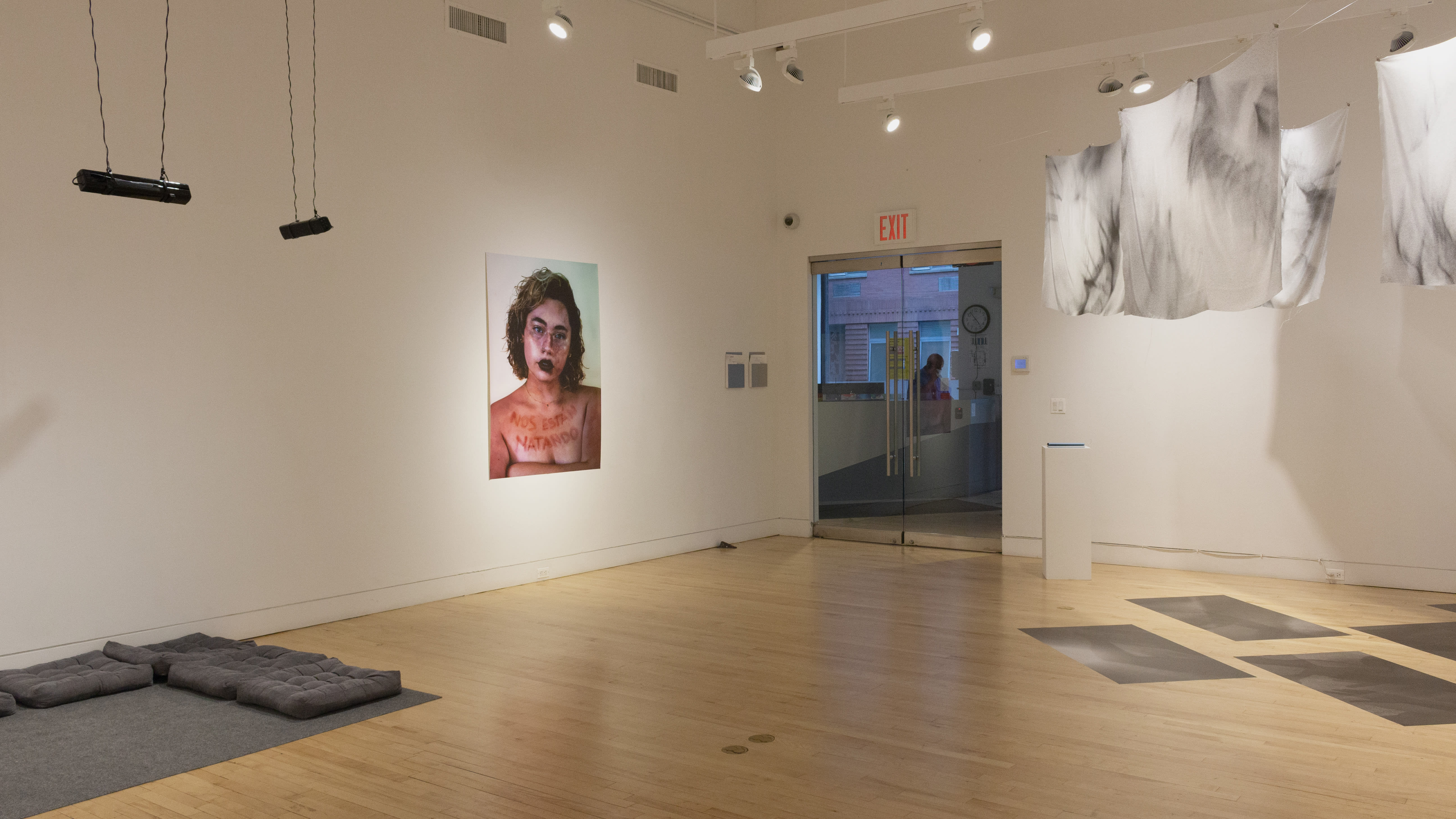 Multiple views of SVA Flatiron Gallery and Windows with installation, photographs, and textile throughout the gallery.