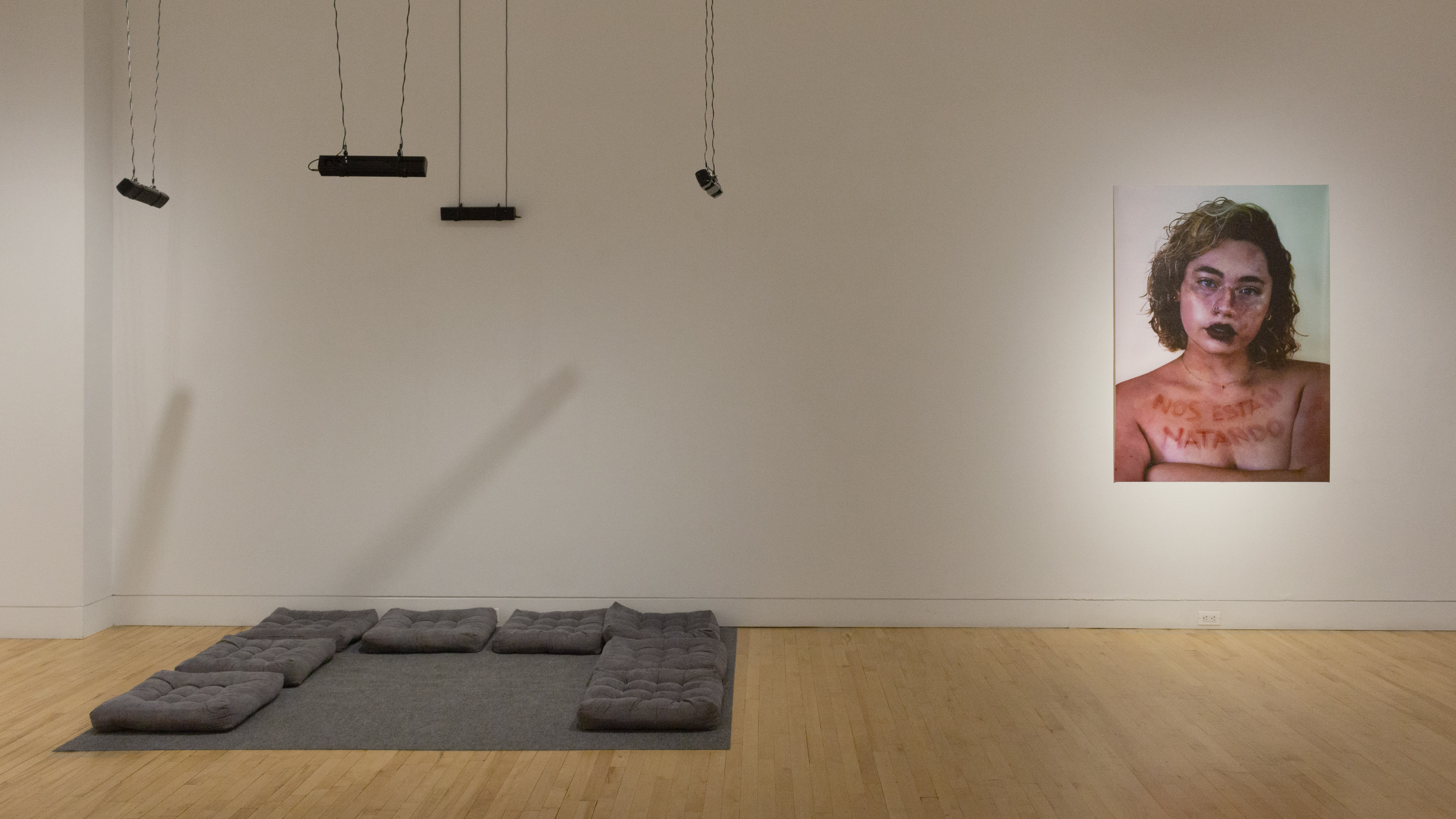 Multiple views of SVA Flatiron Gallery and Windows with installation, photographs, and textile throughout the gallery.