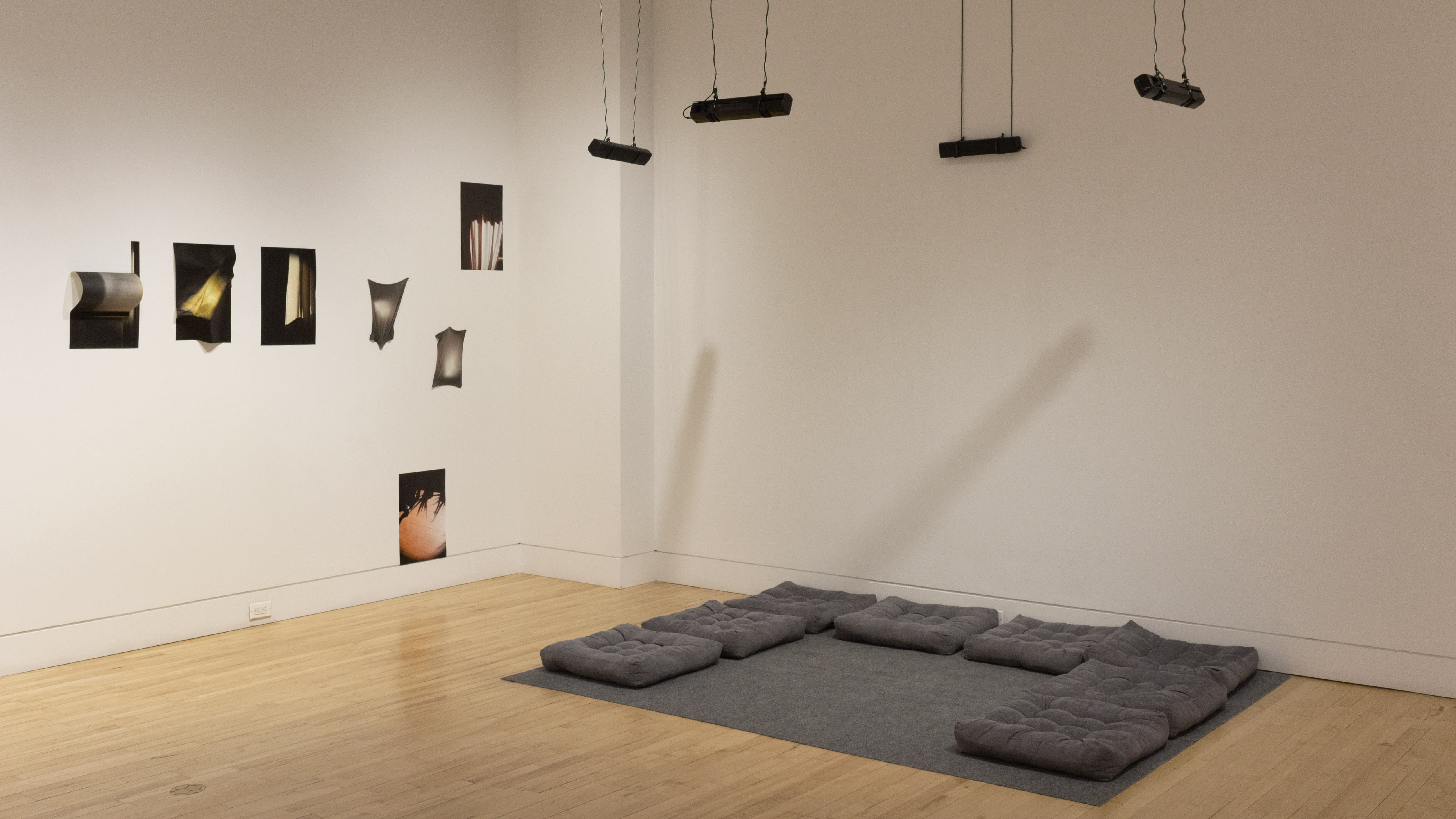 Multiple views of SVA Flatiron Gallery and Windows with installation, photographs, and textile throughout the gallery.