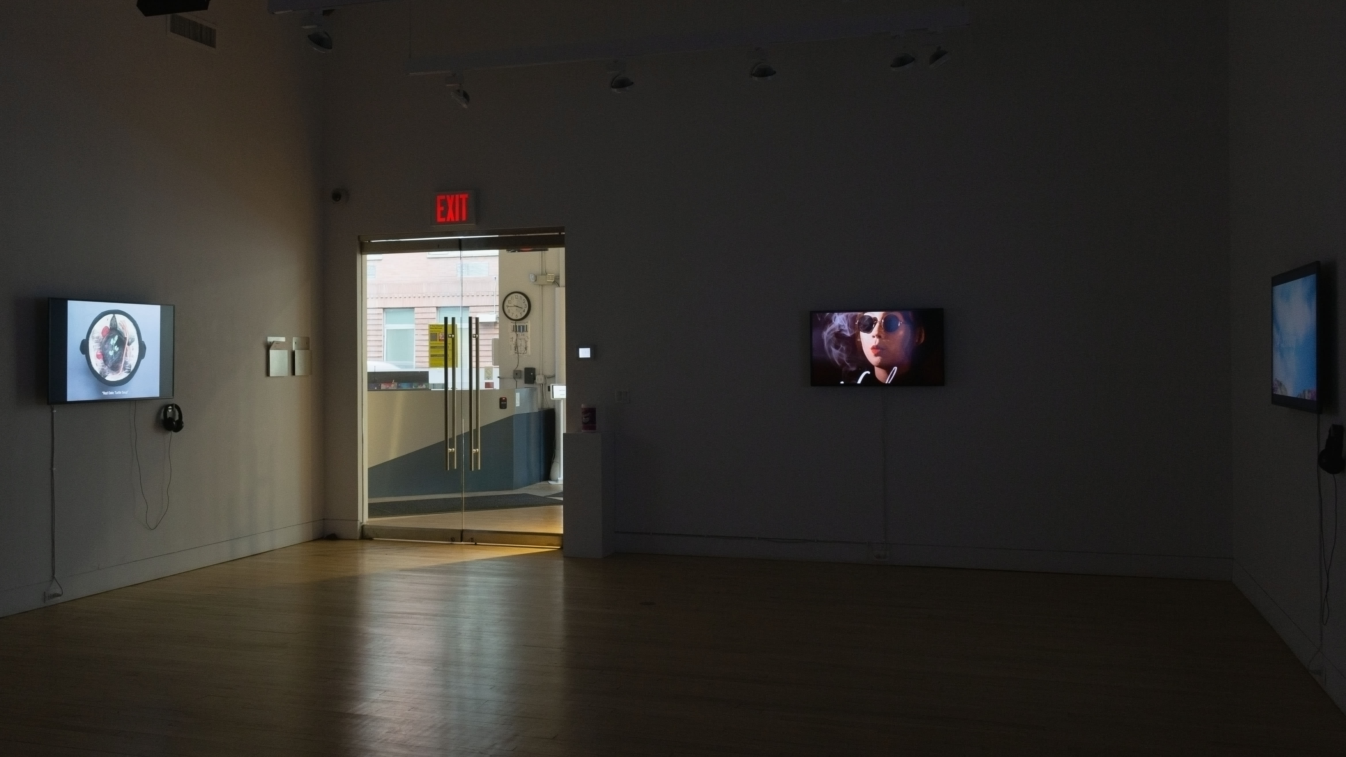 Multiple views of SVA Flatiron Gallery. There are three monitors playing various videos on the wall and an interactive projection.