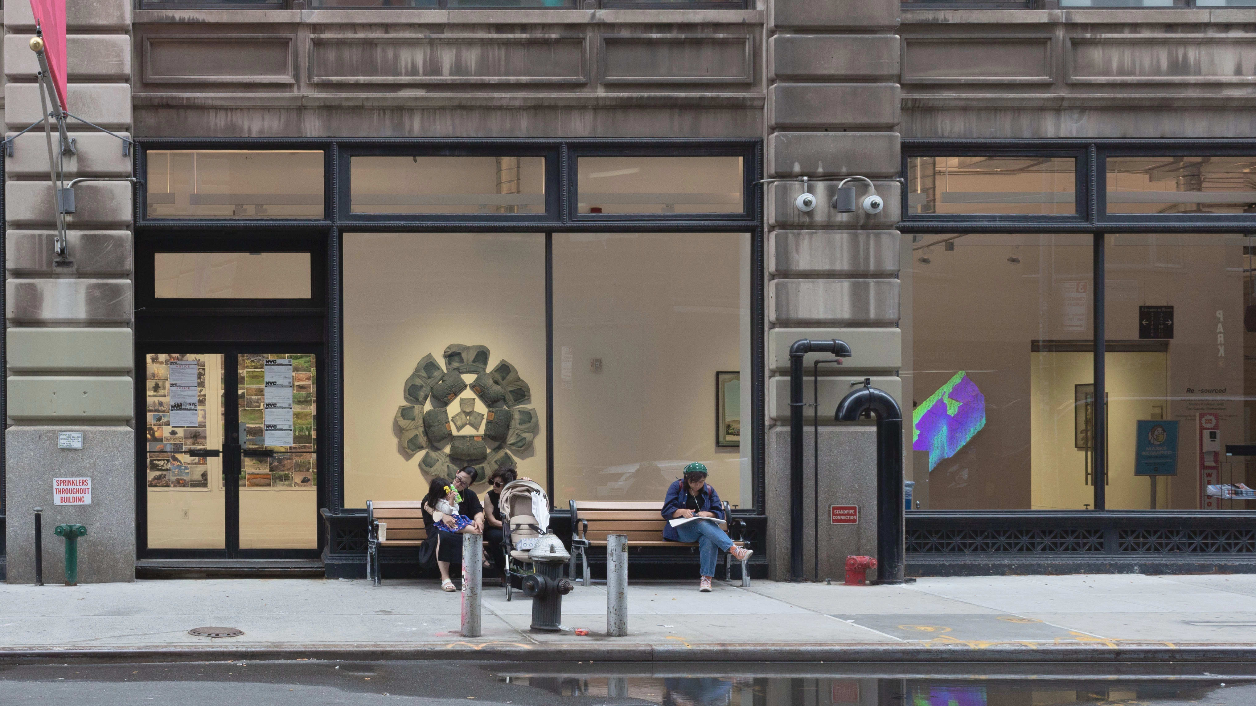 Multiple views of SVA Flatiron Gallery and Windows. There are photographs, collages, and installation work throughout the gallery and displayed in the windows. 