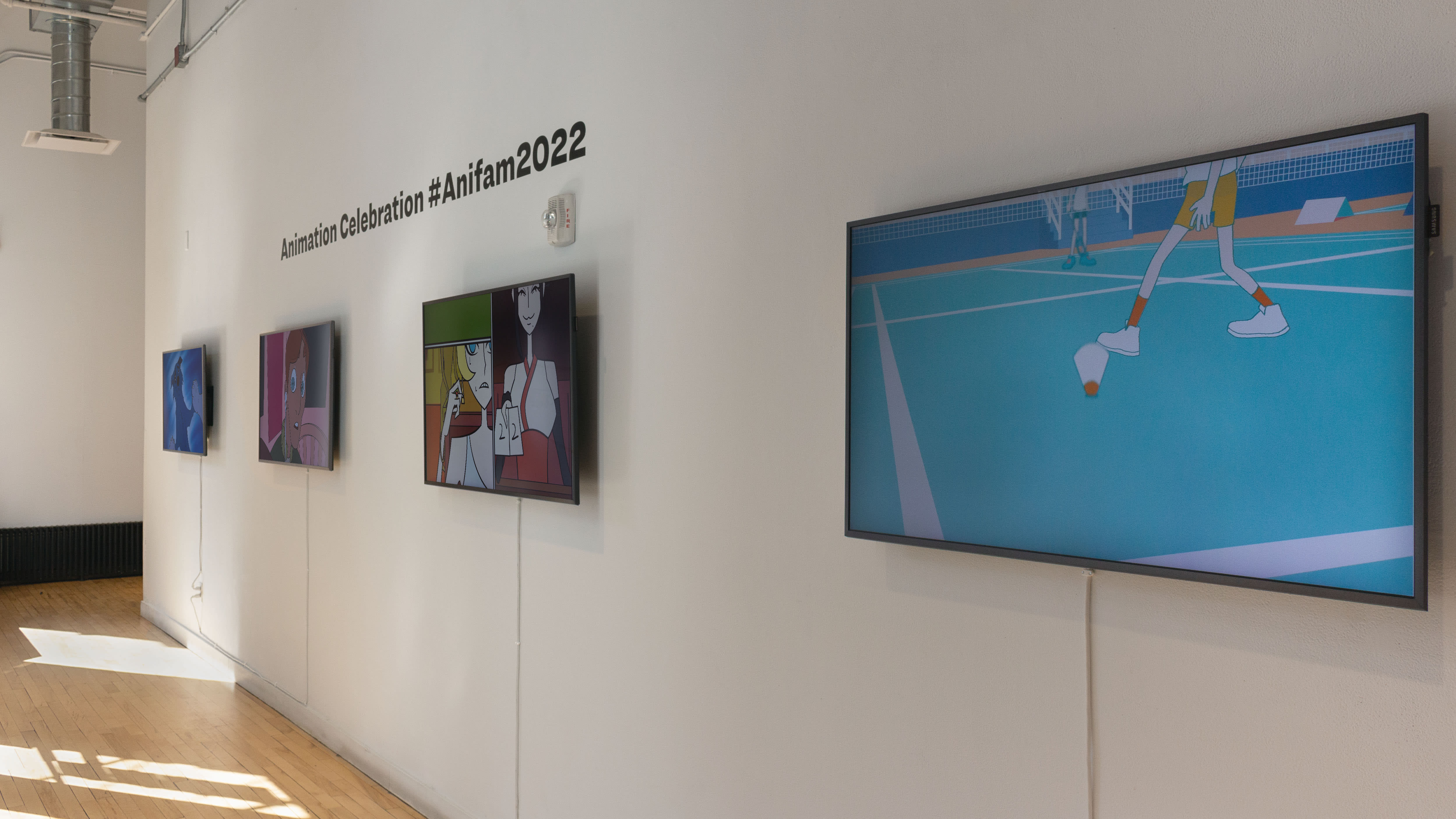 Multiple views of SVA Flatiron Windows and Flatiron Project Space. There are monitors hung in the Windows with films playing and film posters hung in the Flatiron Project Space.