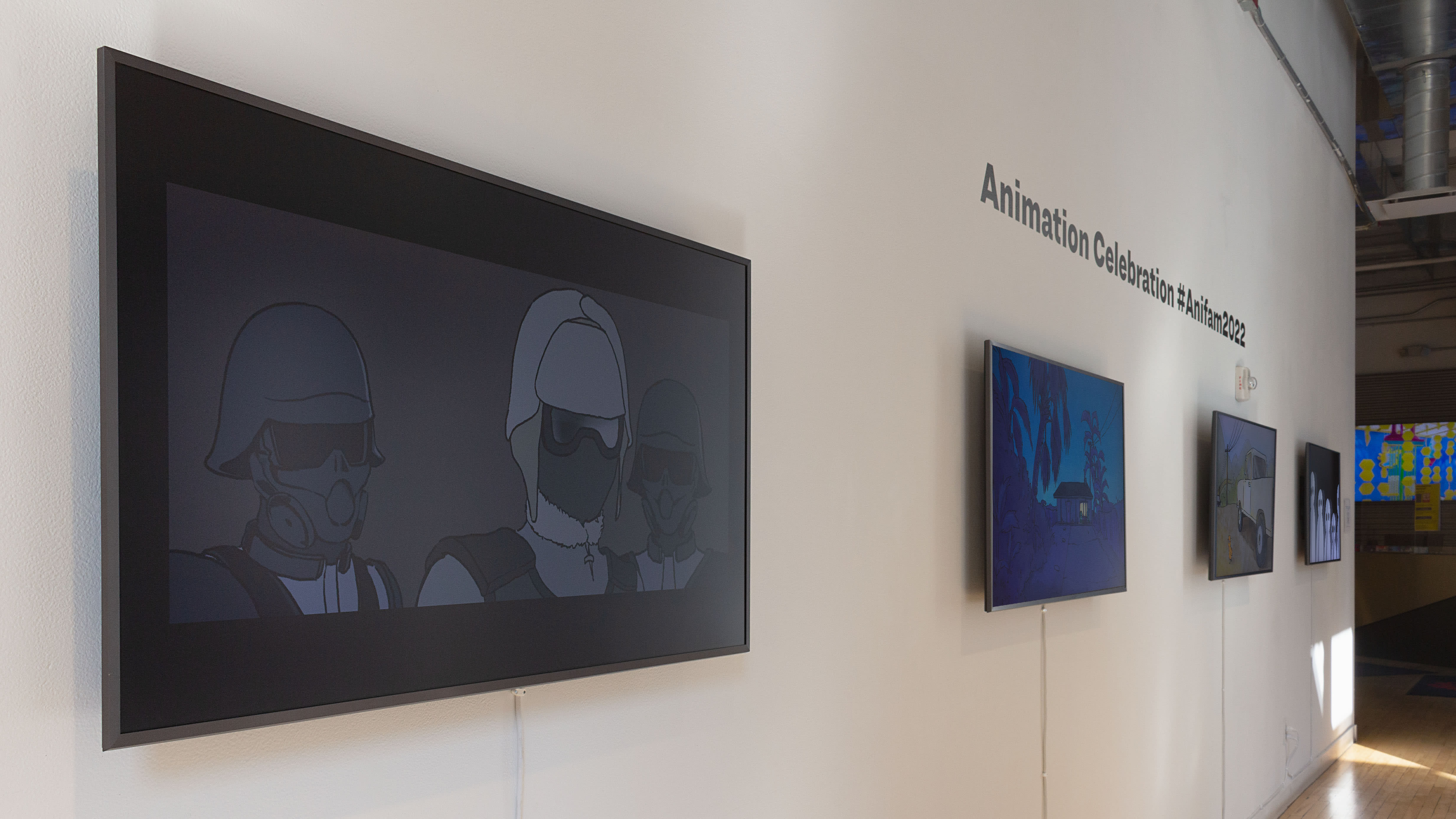 Multiple views of SVA Flatiron Windows and Flatiron Project Space. There are monitors hung in the Windows with films playing and film posters hung in the Flatiron Project Space.