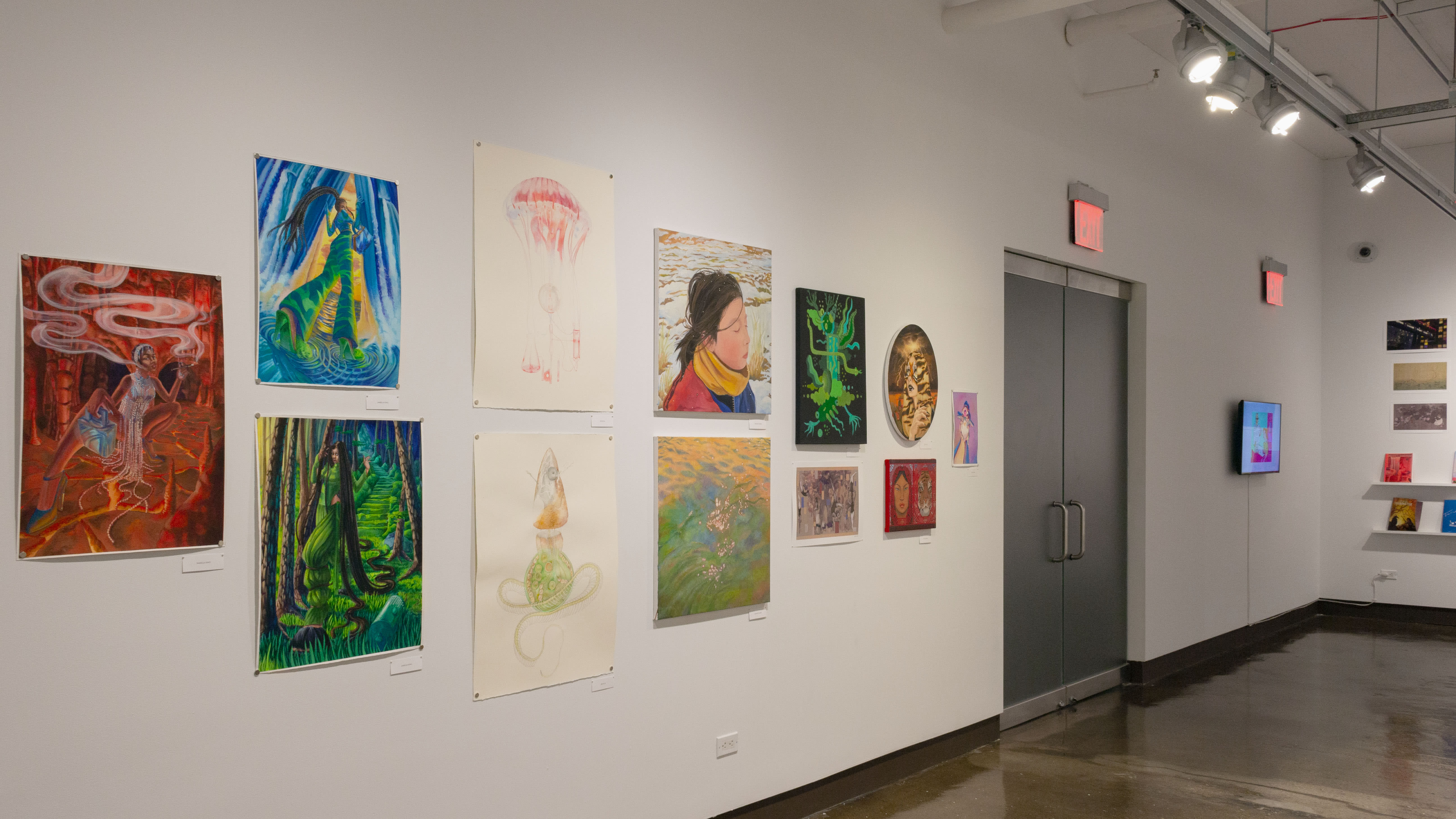 Multiple views of SVA Chelsea Gallery. There is illustrations and paintings hung on the walls. There are multiple shelves throughout the gallery with books places on them.
