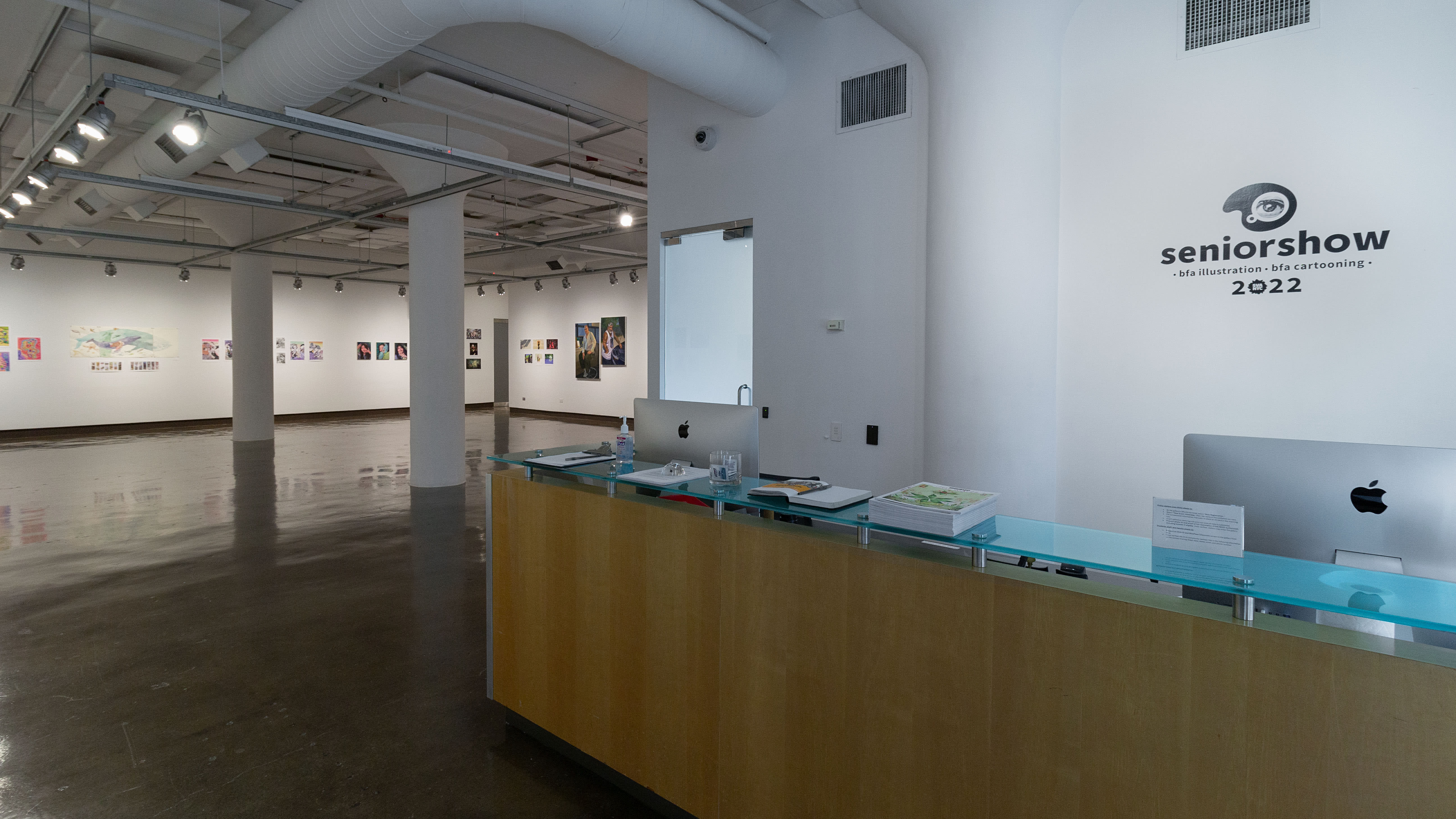 Multiple views of SVA Chelsea Gallery. There is illustrations and paintings hung on the walls. There are multiple shelves throughout the gallery with books places on them.