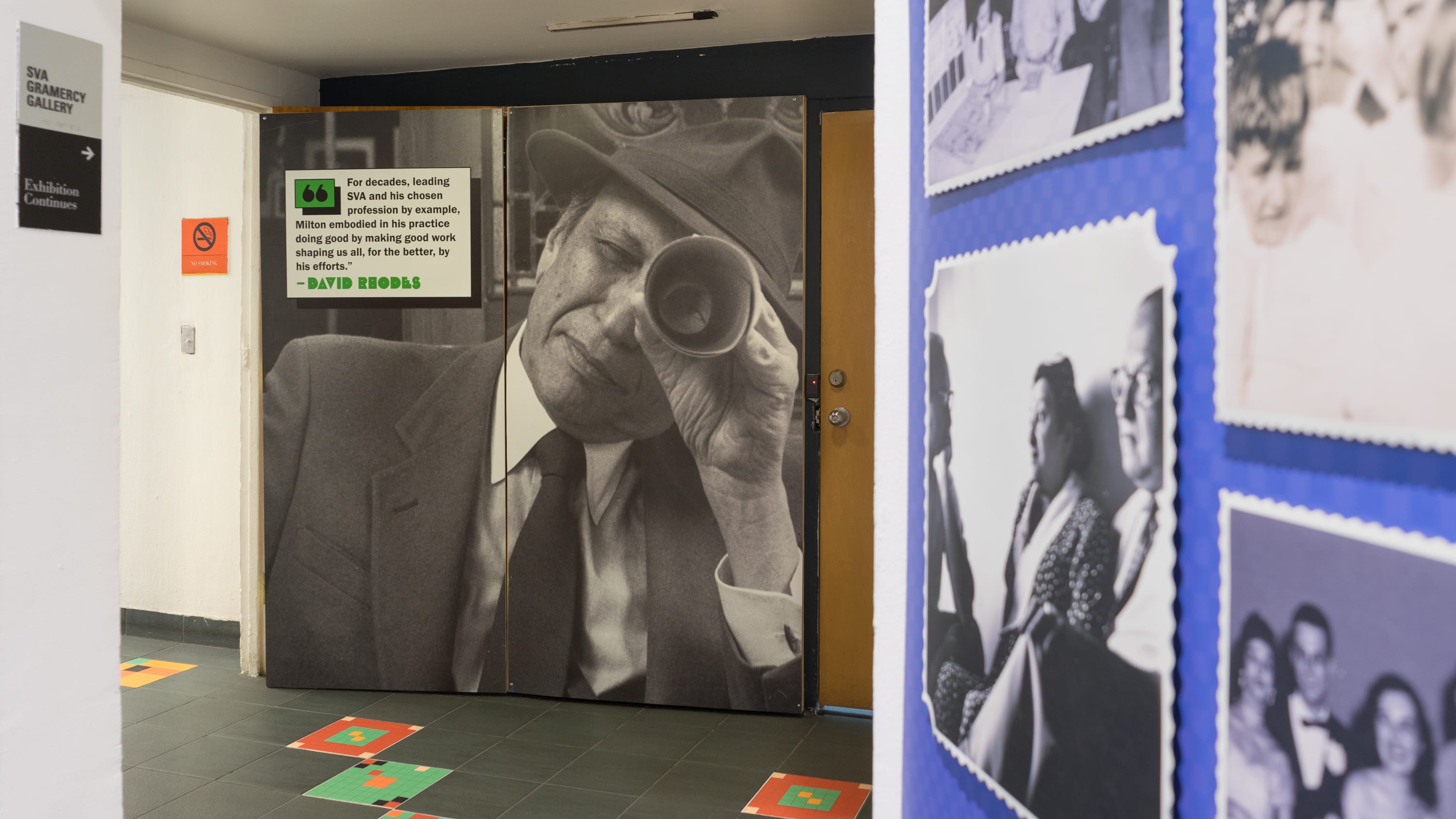 Photograph of Milton Glaser peering through a cylinder at the viewer in-between two gallery spaces, with a quote by SVA President David Rhodes.