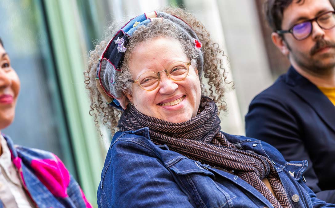Gail Anderson smiles and looks to her right during a panel discussion.