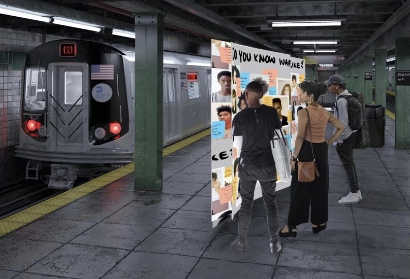  A 3D rendered image of an NYC subway interior is shown. A subway platform is visible, with a train stopped at the station on the left side of the image.On the platform to the right, a large panel is shown with handwritten text at the top of the panel. The panel shows a map of the NYC subway with images of people’s faces pasted on different parts of the map