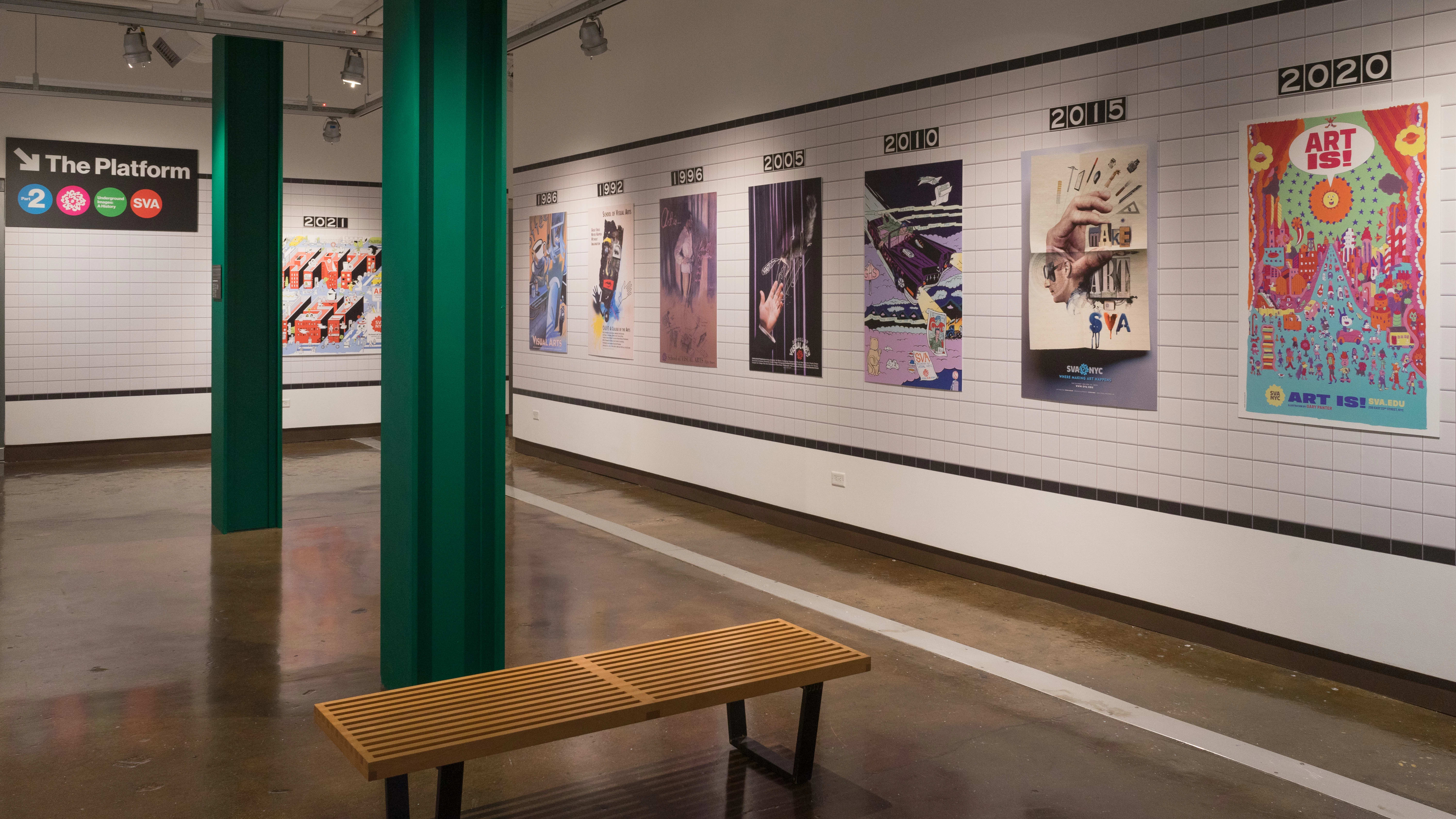 Row of subway posters installed on a faux tile background inside an art gallery.
