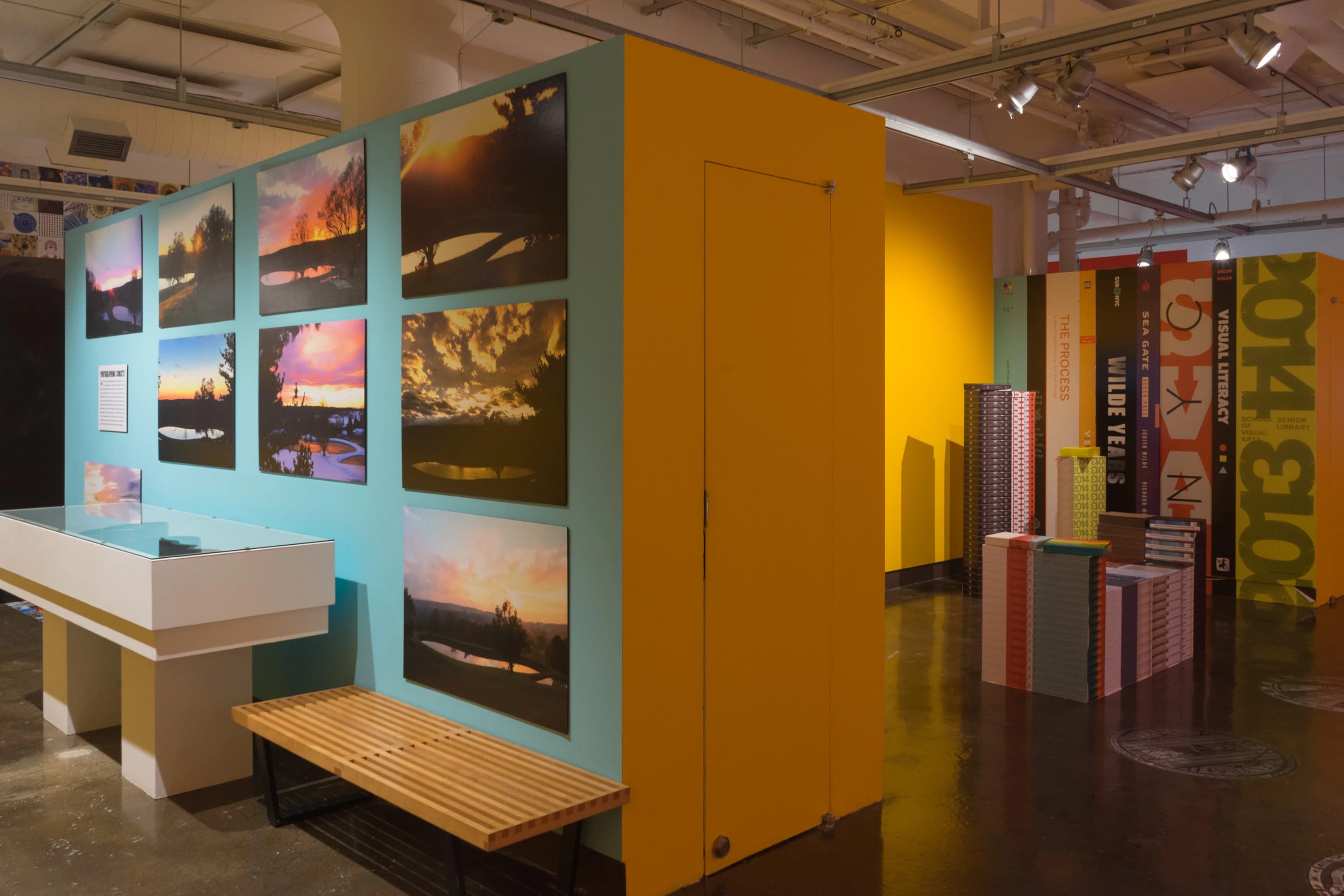 A blue wall shows images of sunsets Wilde has photographed.