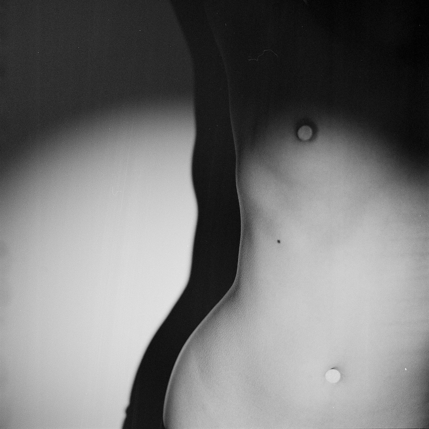  Close-up of a human torso with a visible belly button.