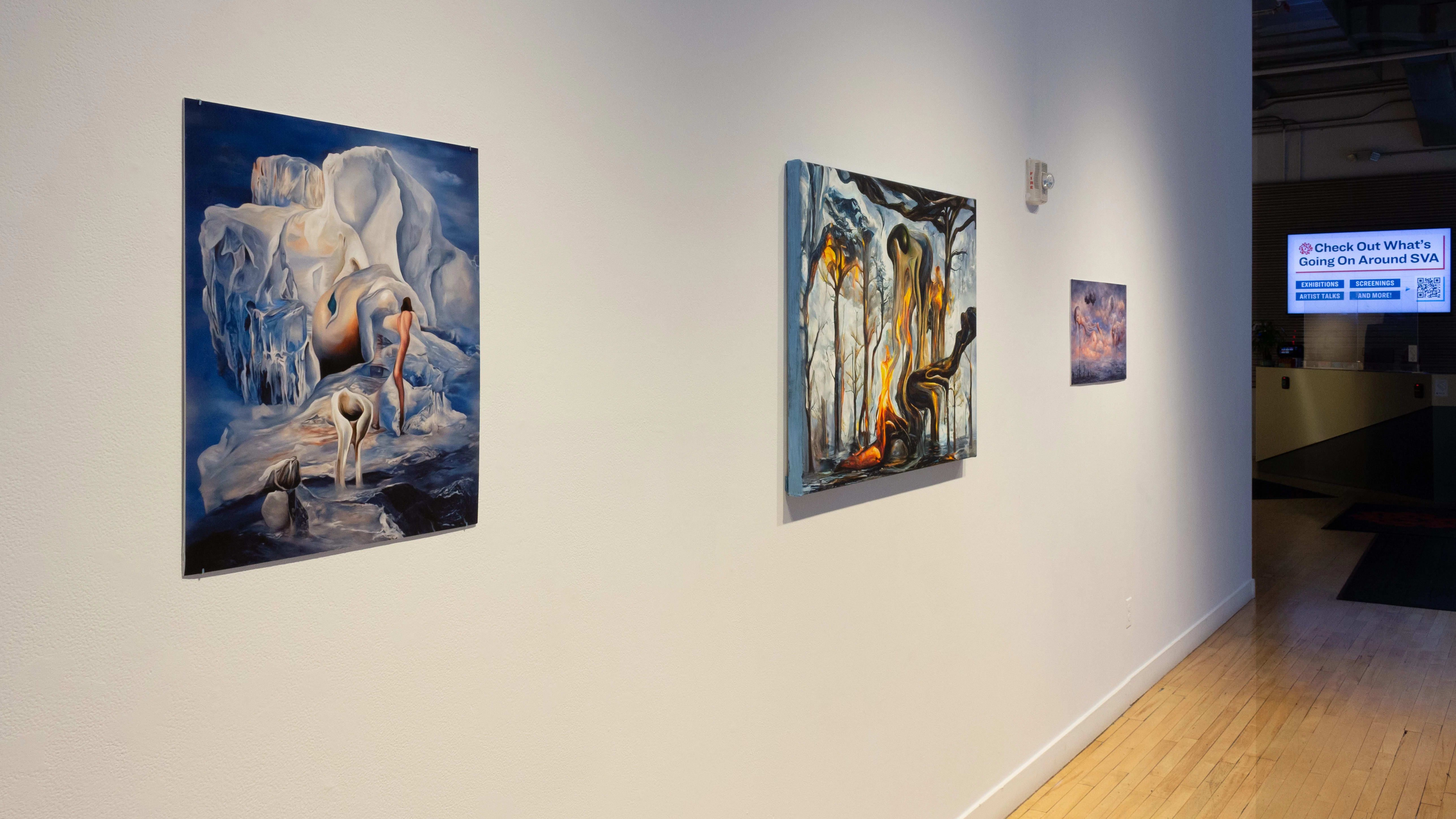 Installation image showing an agled view of three paintings with a monitor in the background.n