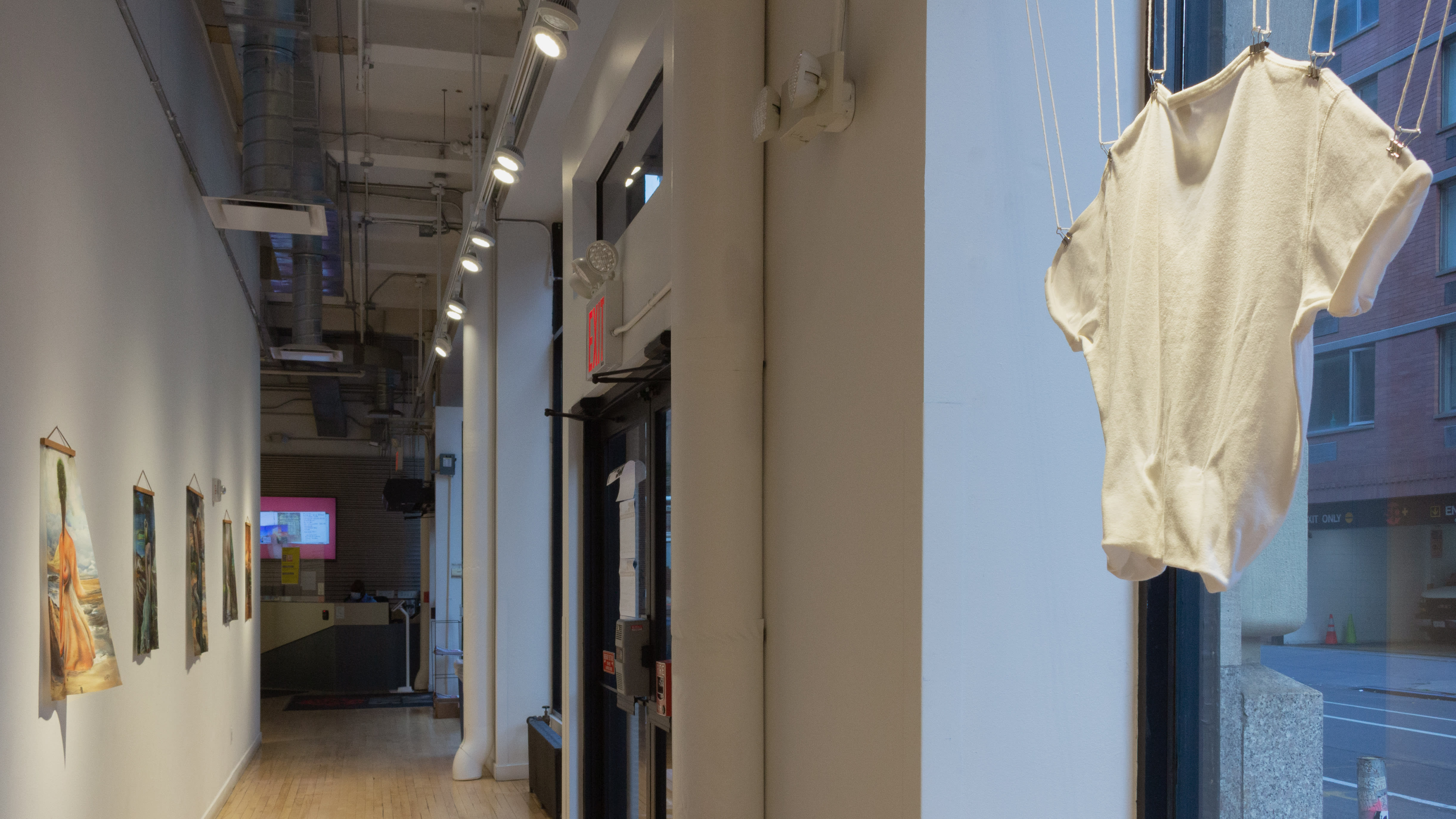 Multiple views of SVA Flatiron Gallery and Windows with installation, photographs, and textile throughout the gallery.