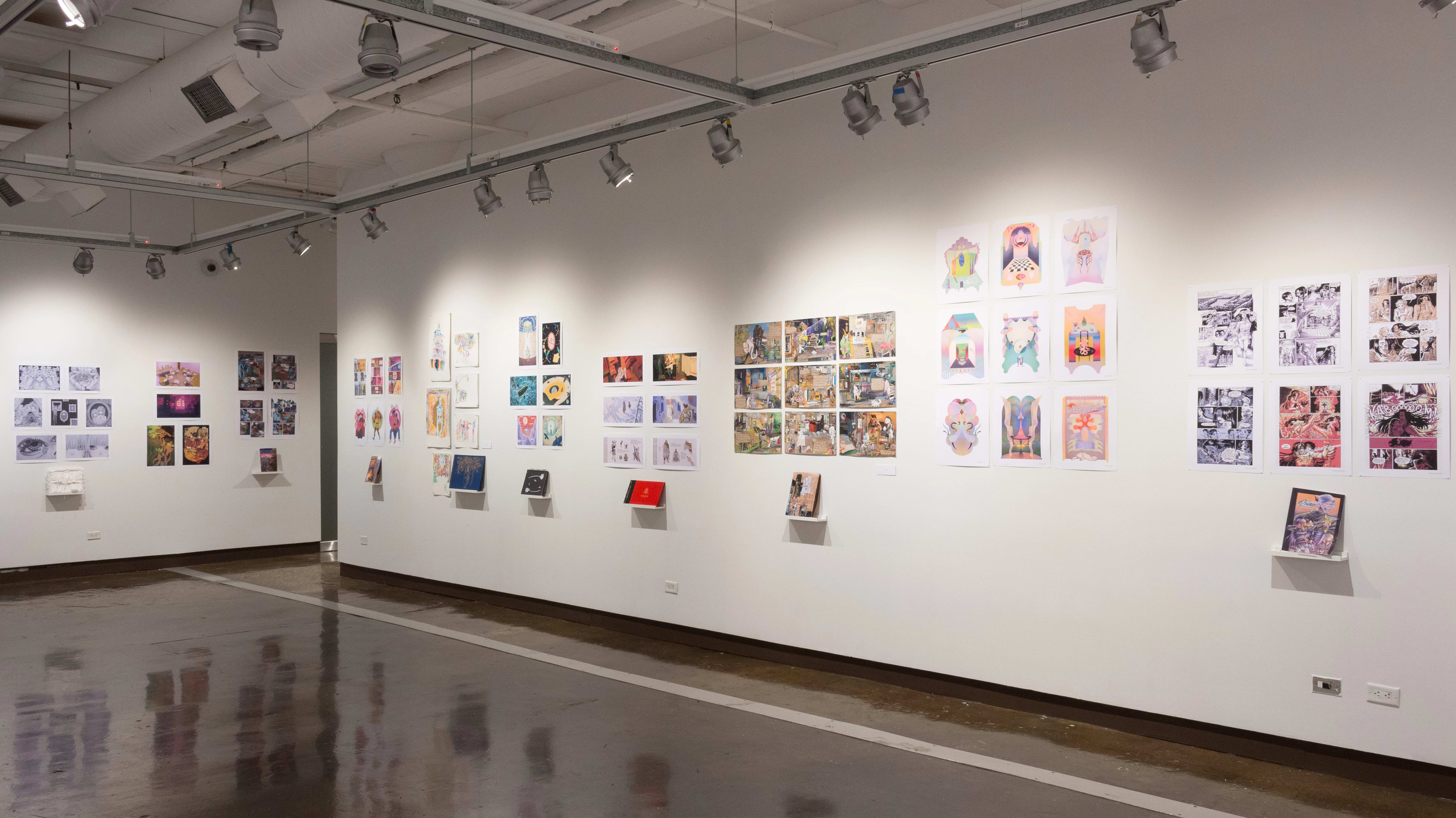 In the second gallery space, many student projects with books, prints, and original works are on view. They differ in style, color, and dimensions.