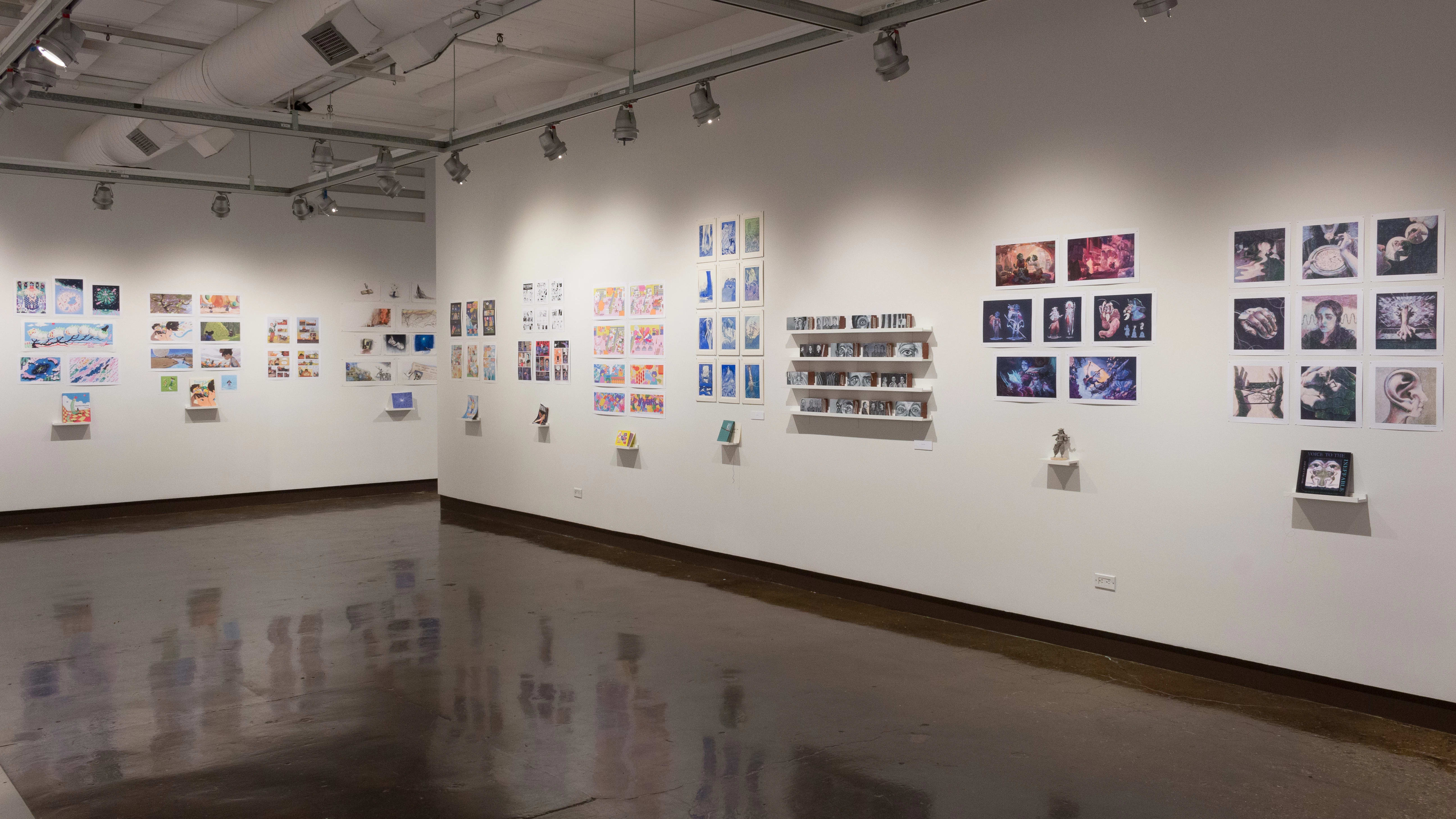 More prints are displayed above students’ books. One project does not have prints – Instead, several block-like sculptures sit on four shelves.