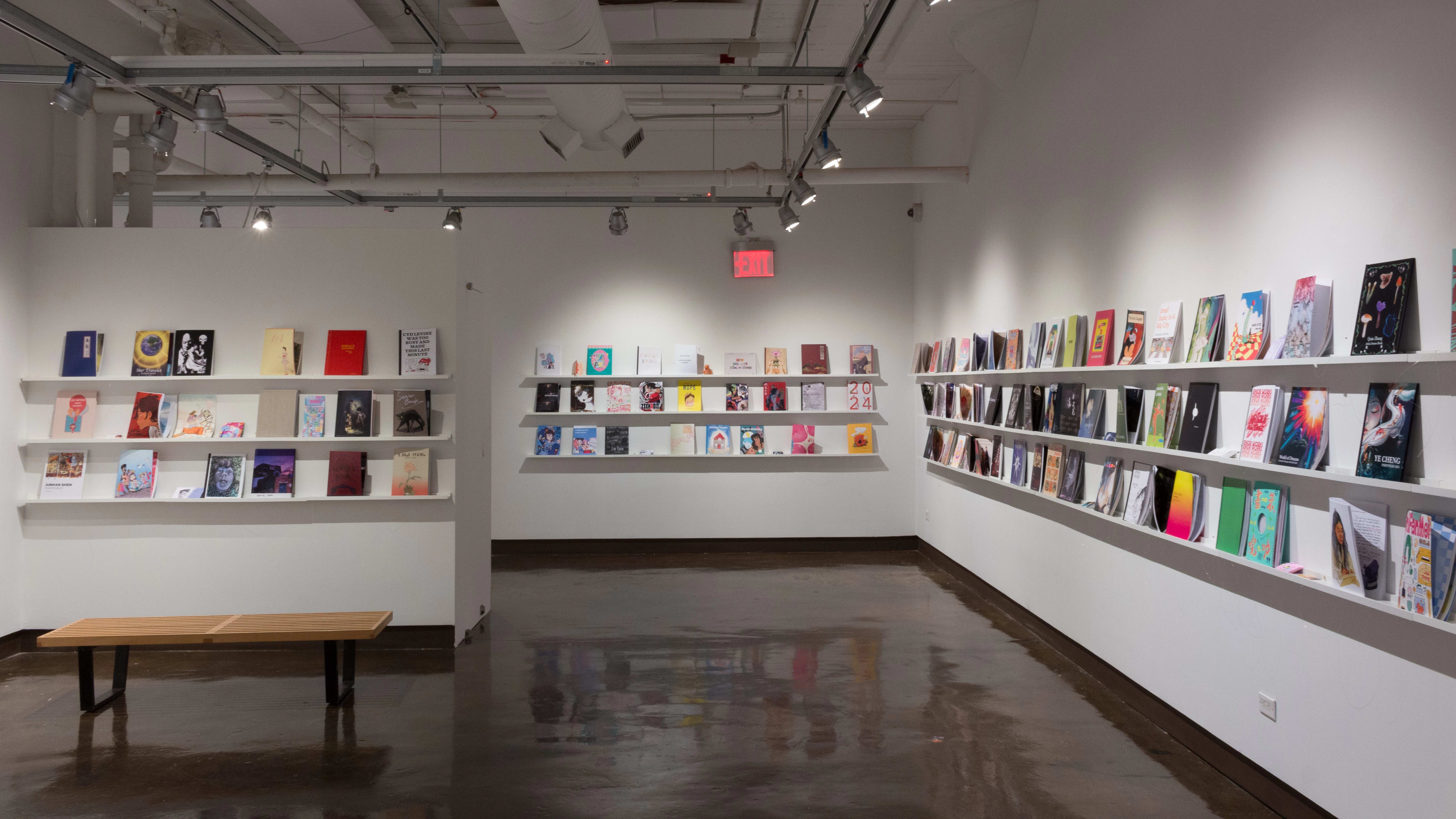 Colorful books are displayed in three rows, lining the walls of gallery four.