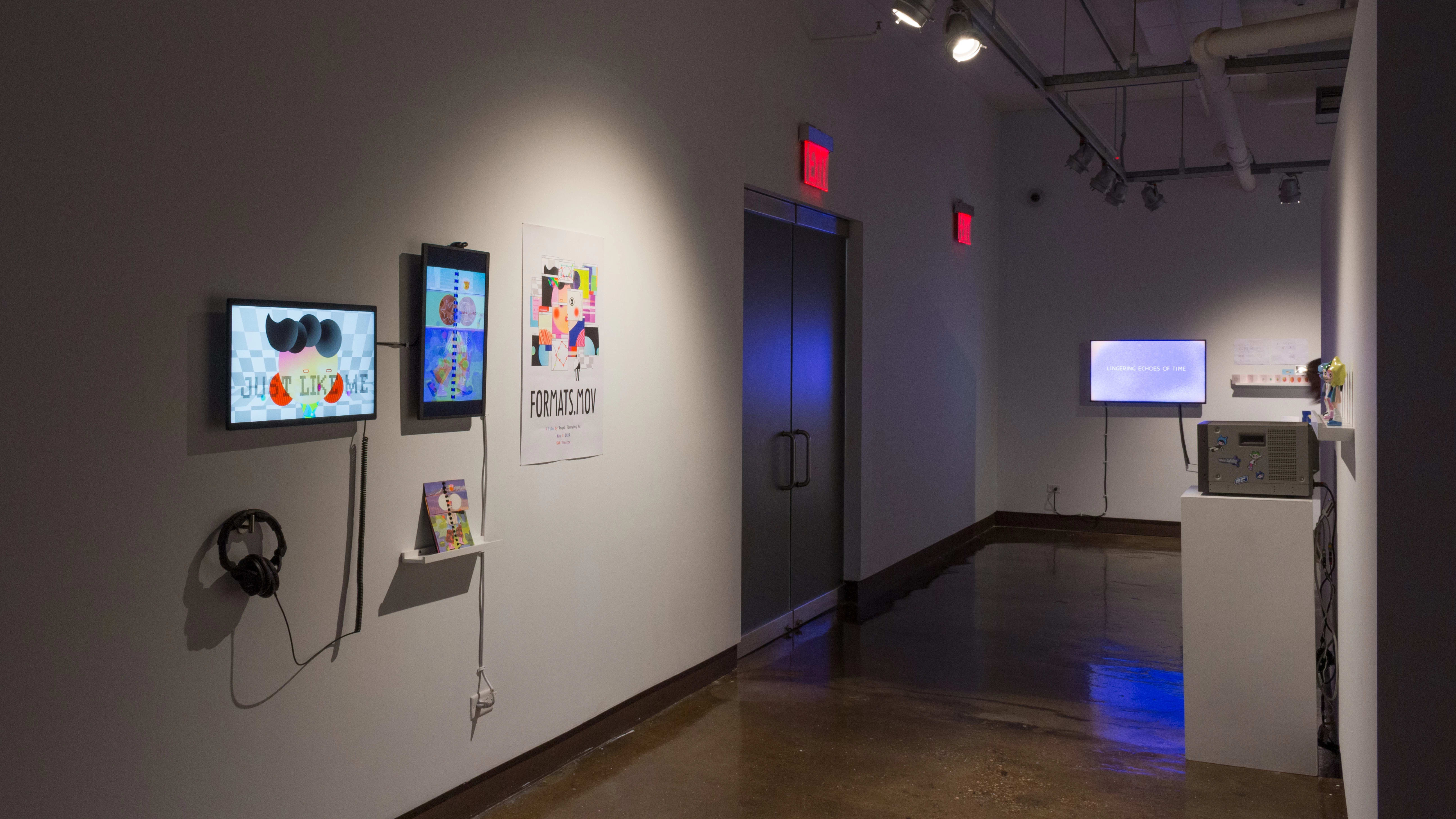 Angled image showing several monitors playing various animated films, with two doors in the middle ground.