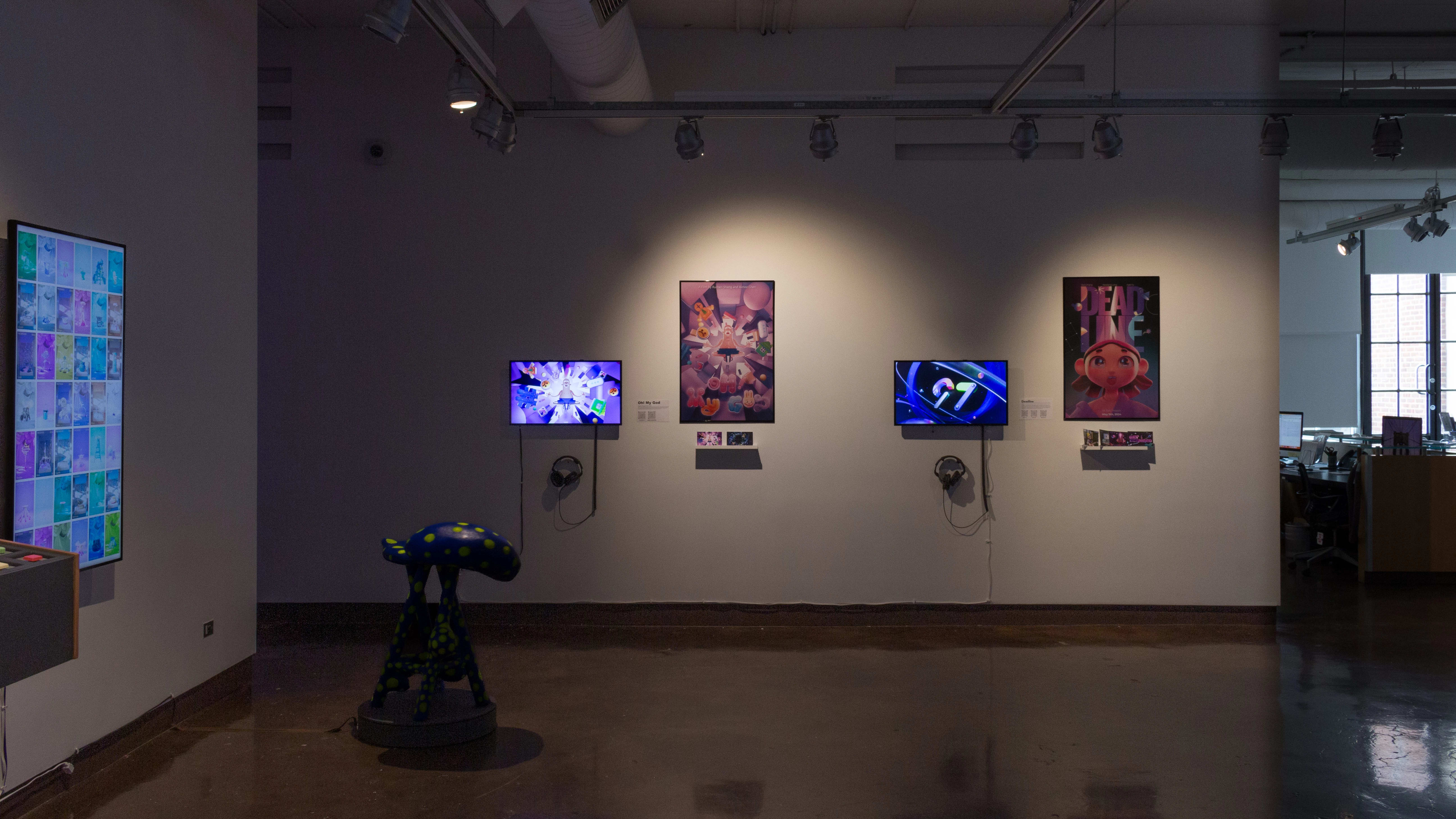 Installation image showing an interactice installation with a spinning stool, two monitors playing animated reels with posters in between.