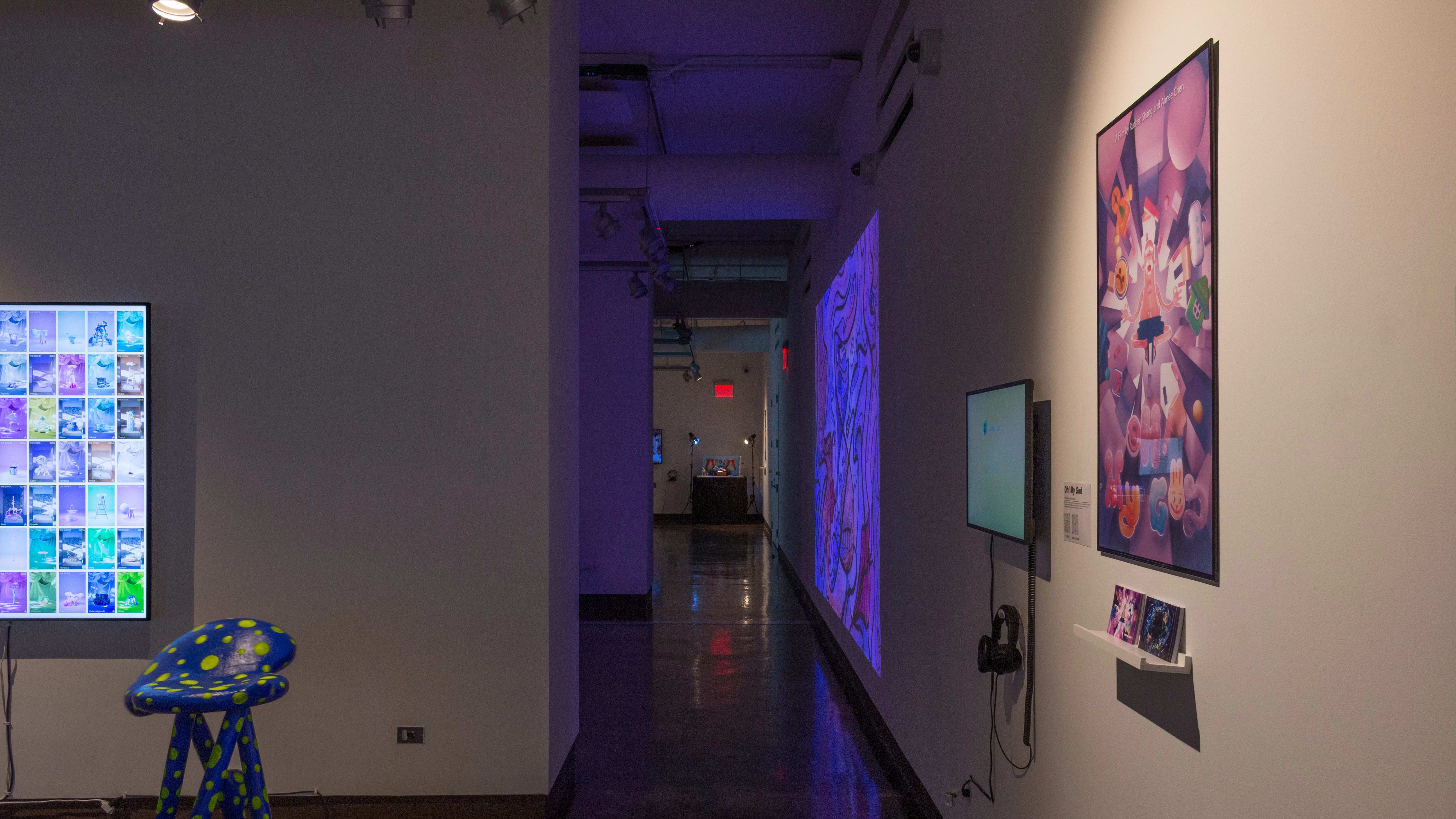 A long hallway to the right of several gallery spaces, with projections and installations visible in the background.