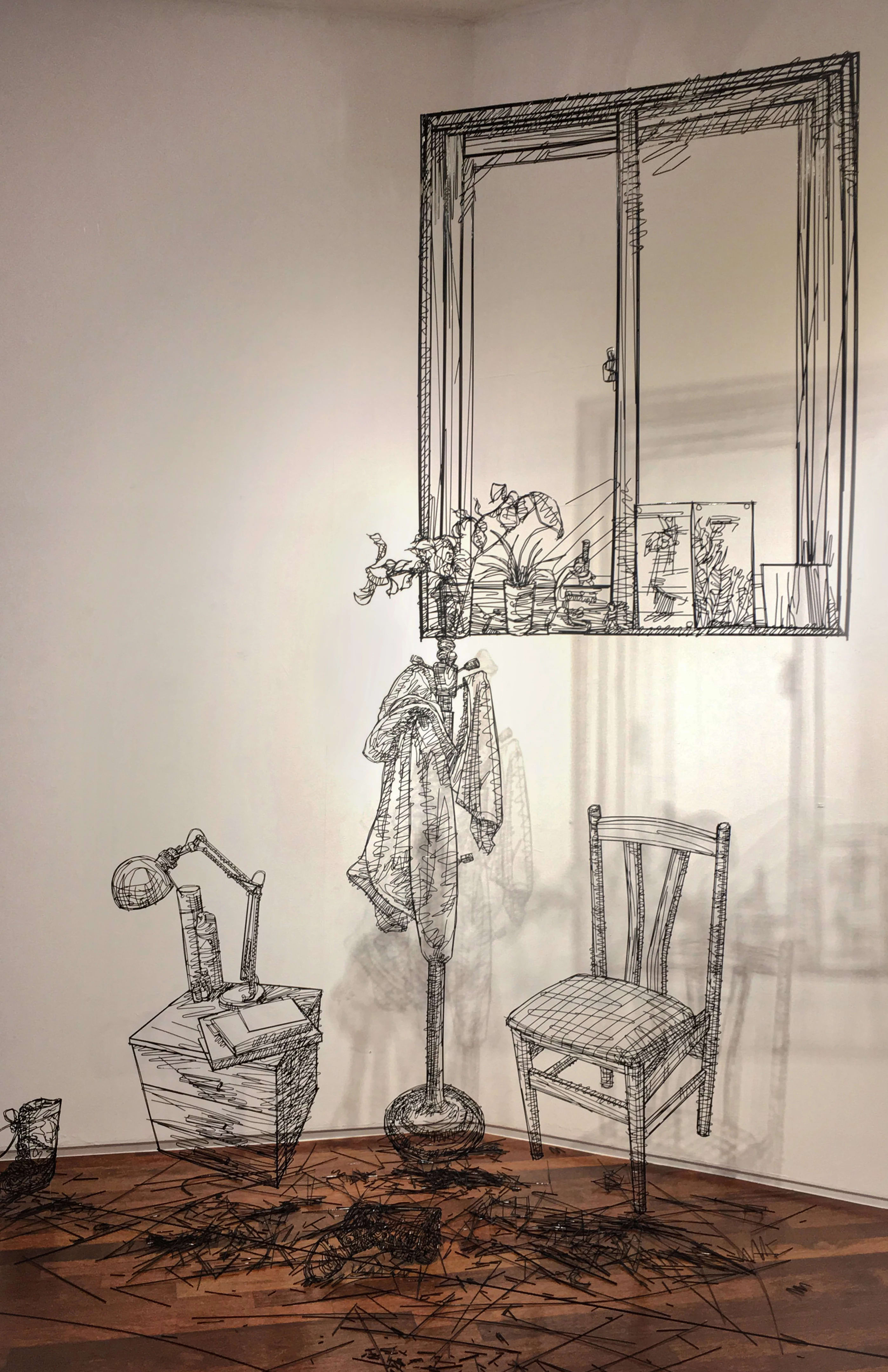 Sculptures made in black wire depicting the inside of a room. Including a wooden chair, a coat rack, a bedside table with a lamp and a window above them.