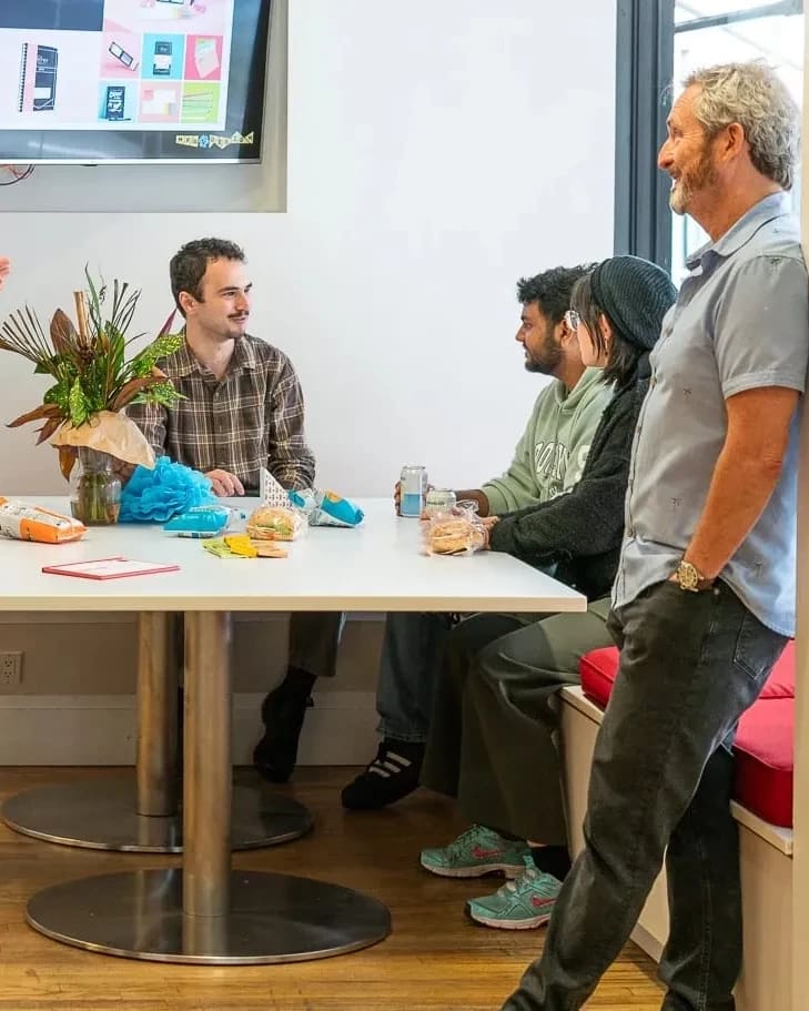 People congregating in an open plan, community oriented lounge.