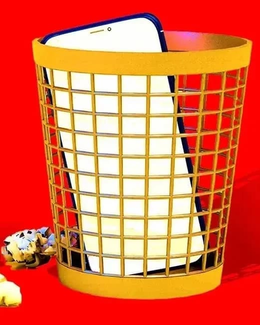 A cell phone discarded in a trash can, set against a vibrant red background