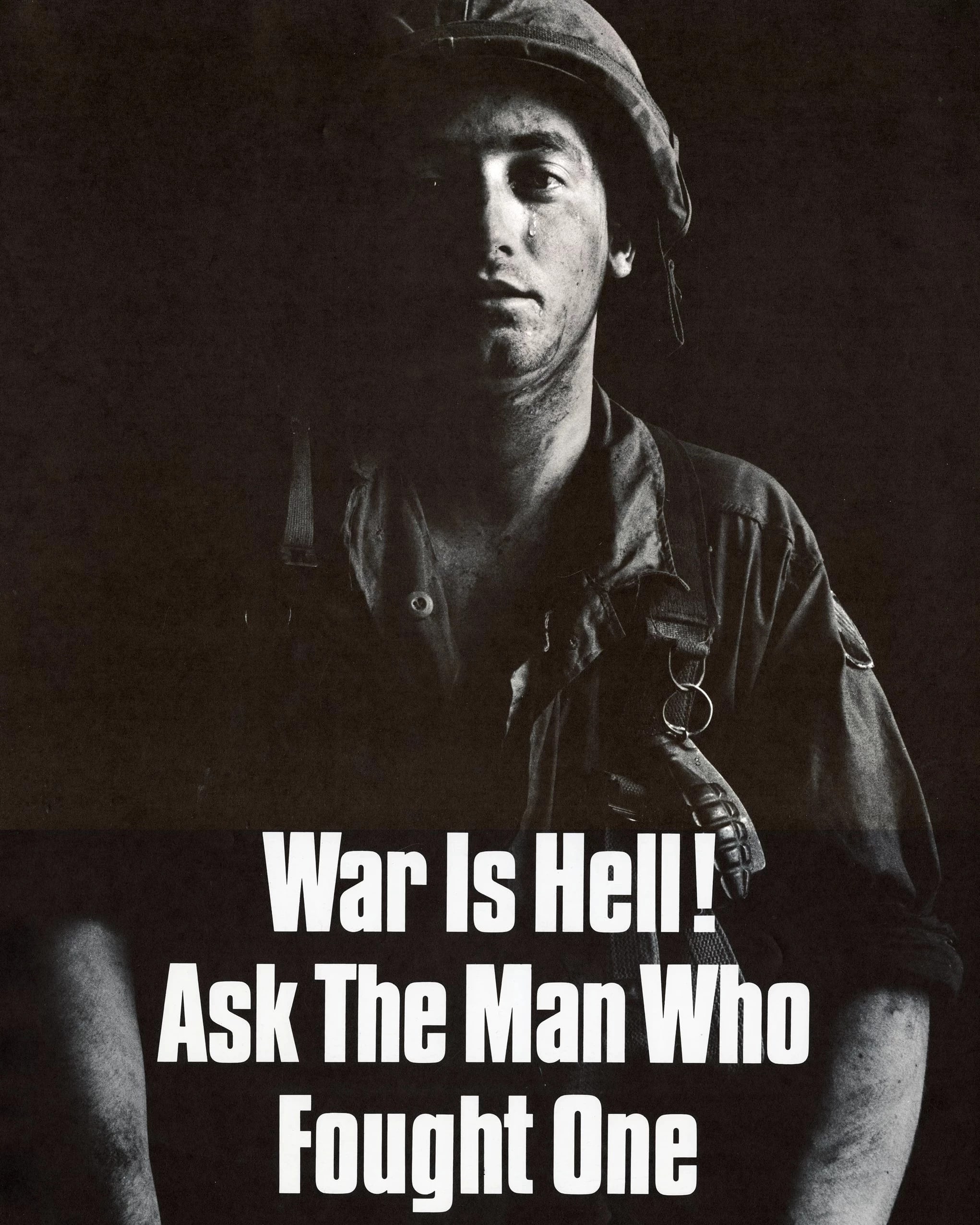 A poster against the Vietnam War, depicting a black and white picture of a soldier with a tear streaming down his face. The words "War is Hell! Ask the man who fought one" are written in bold white letters.