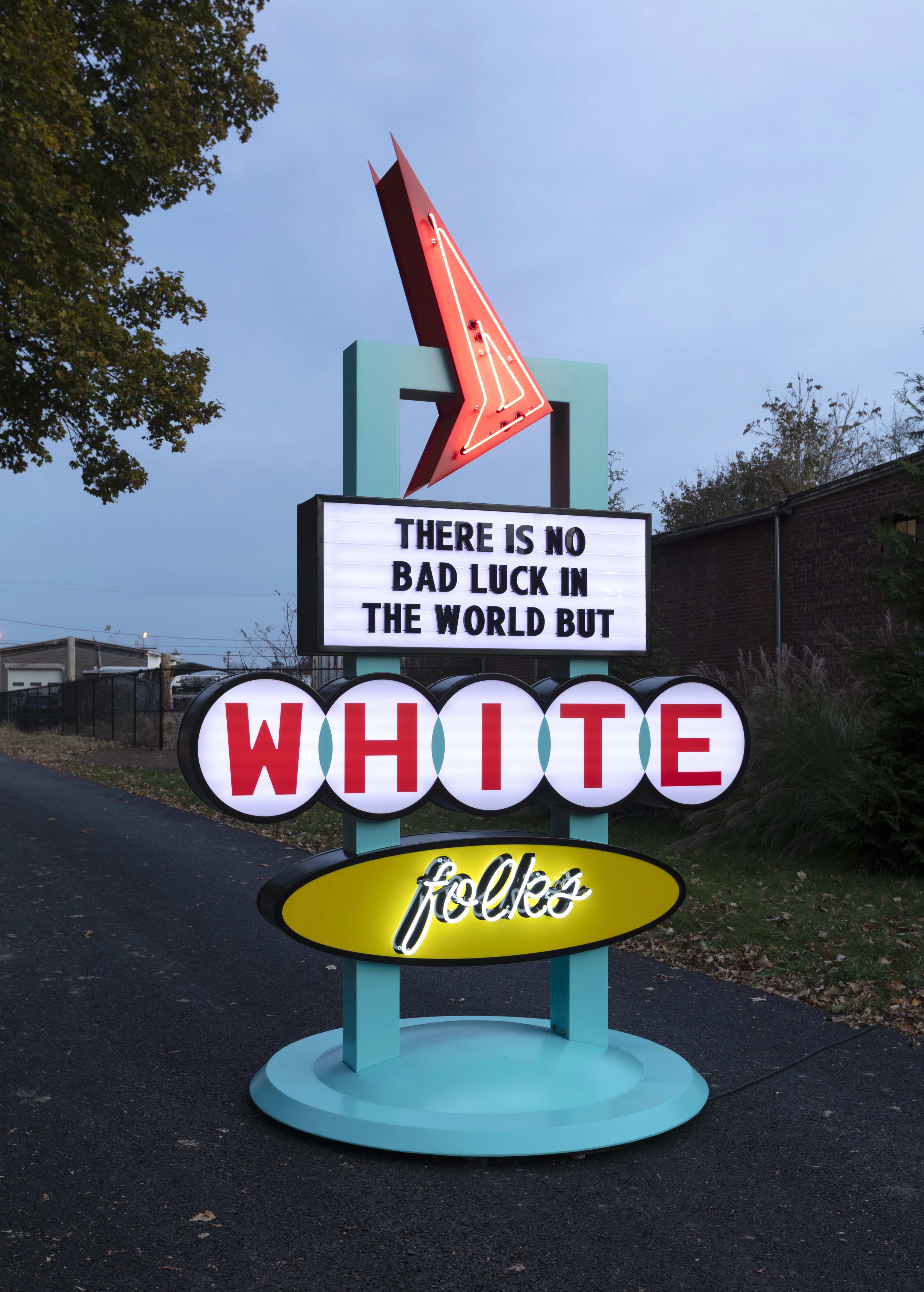 Picture of a large neon sign that reads "There is no bad luck in the world but white folks"