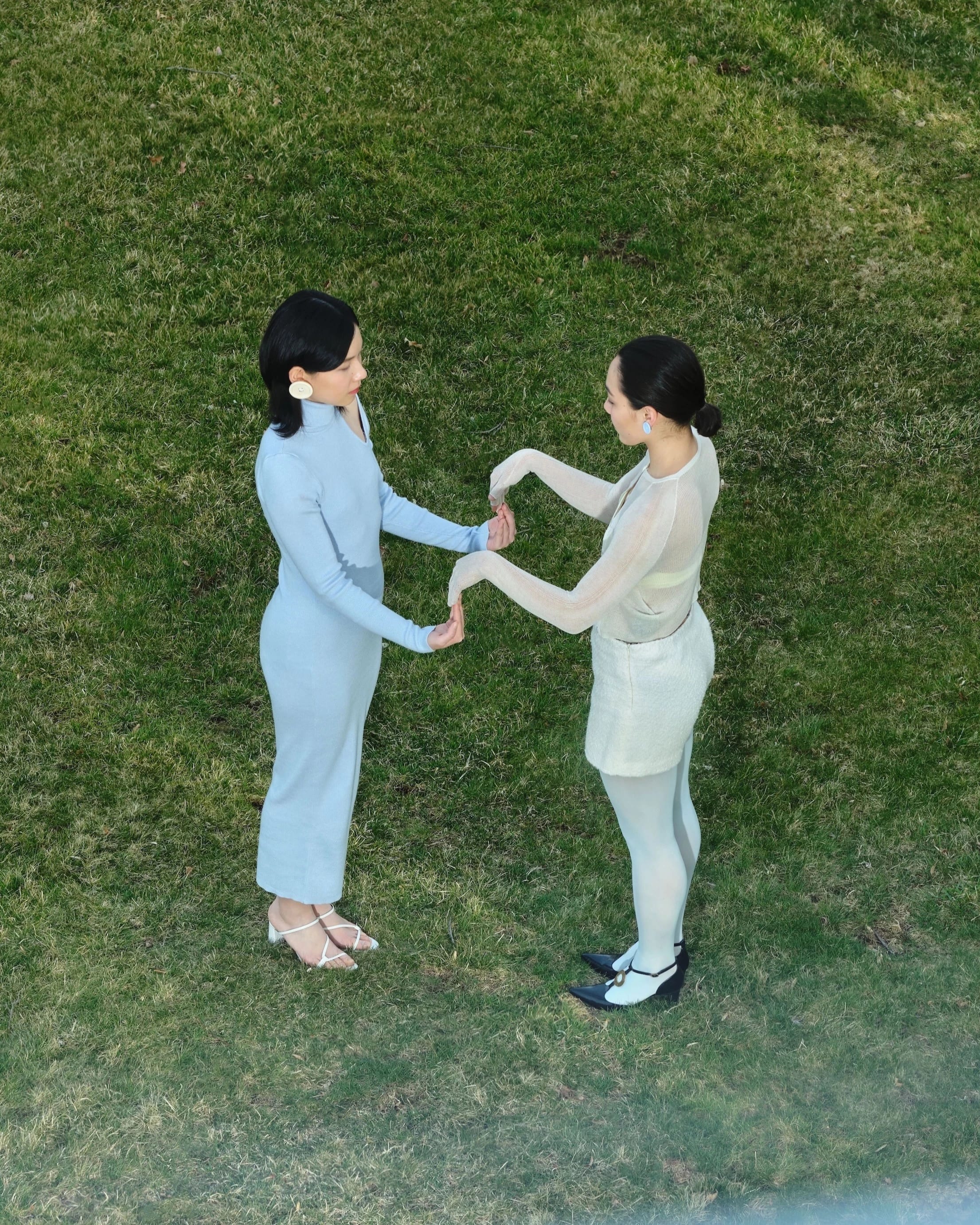 Two people play a hand clap game.