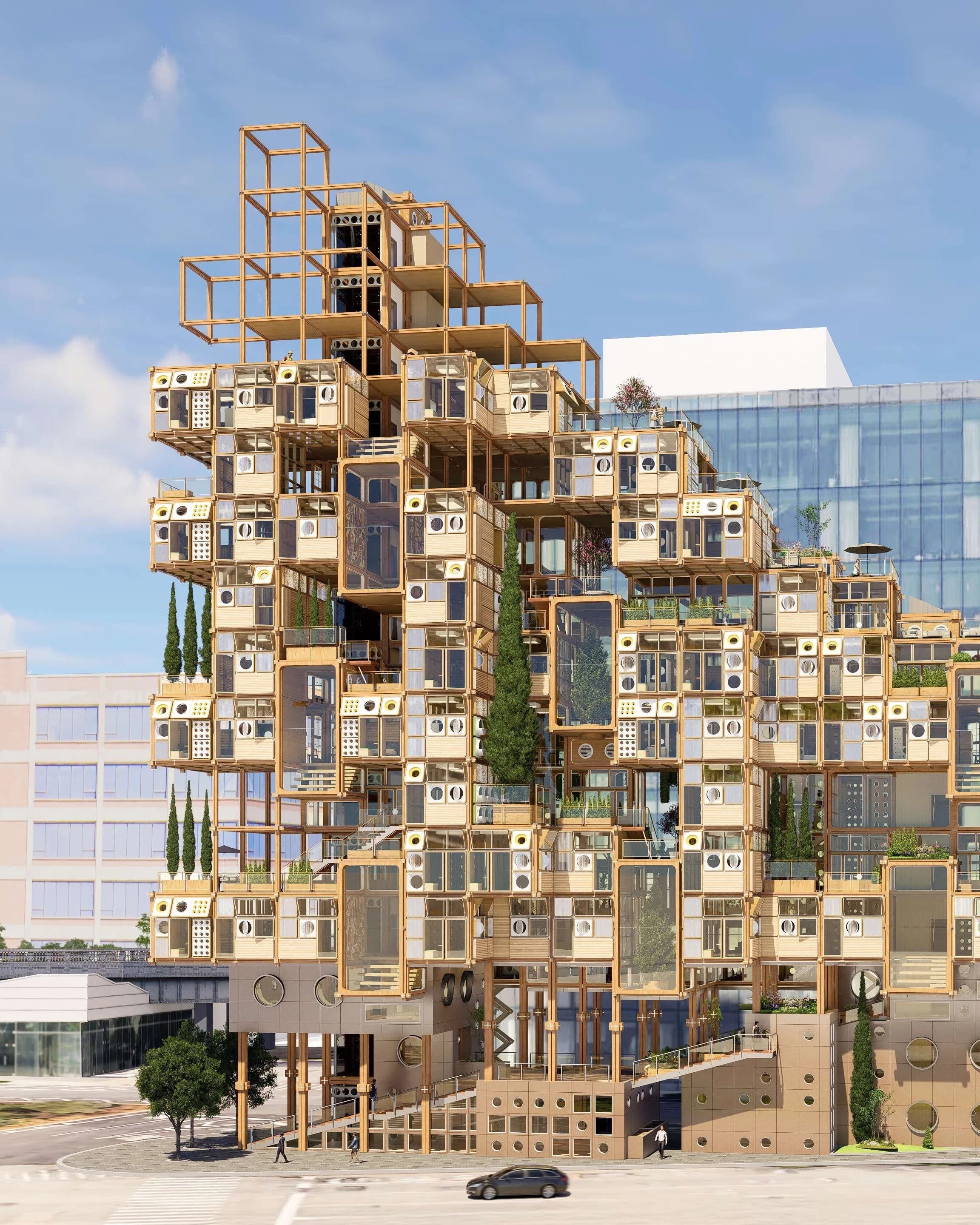 A modular building with a grid of square and circular windows, surrounded by trees. The structure is light brown, giving a modern, geometric feel.
