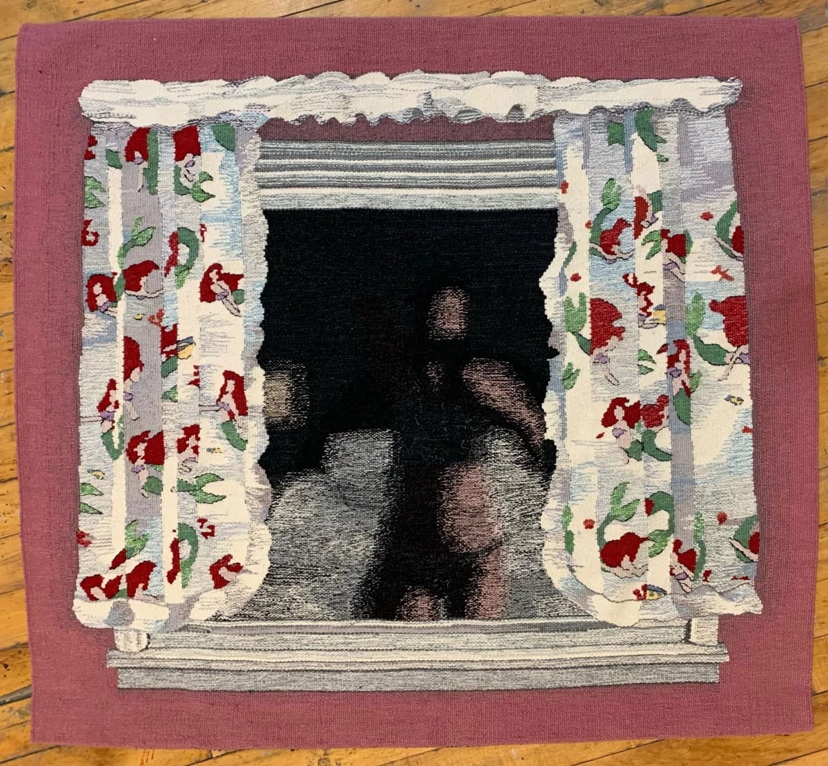 Artwork by Erin M. Riley. The artwork is a tapestry that depicts a window with curtains. The wall surrounding the window is pink and the curtains are white with a red and green pattern across them. 