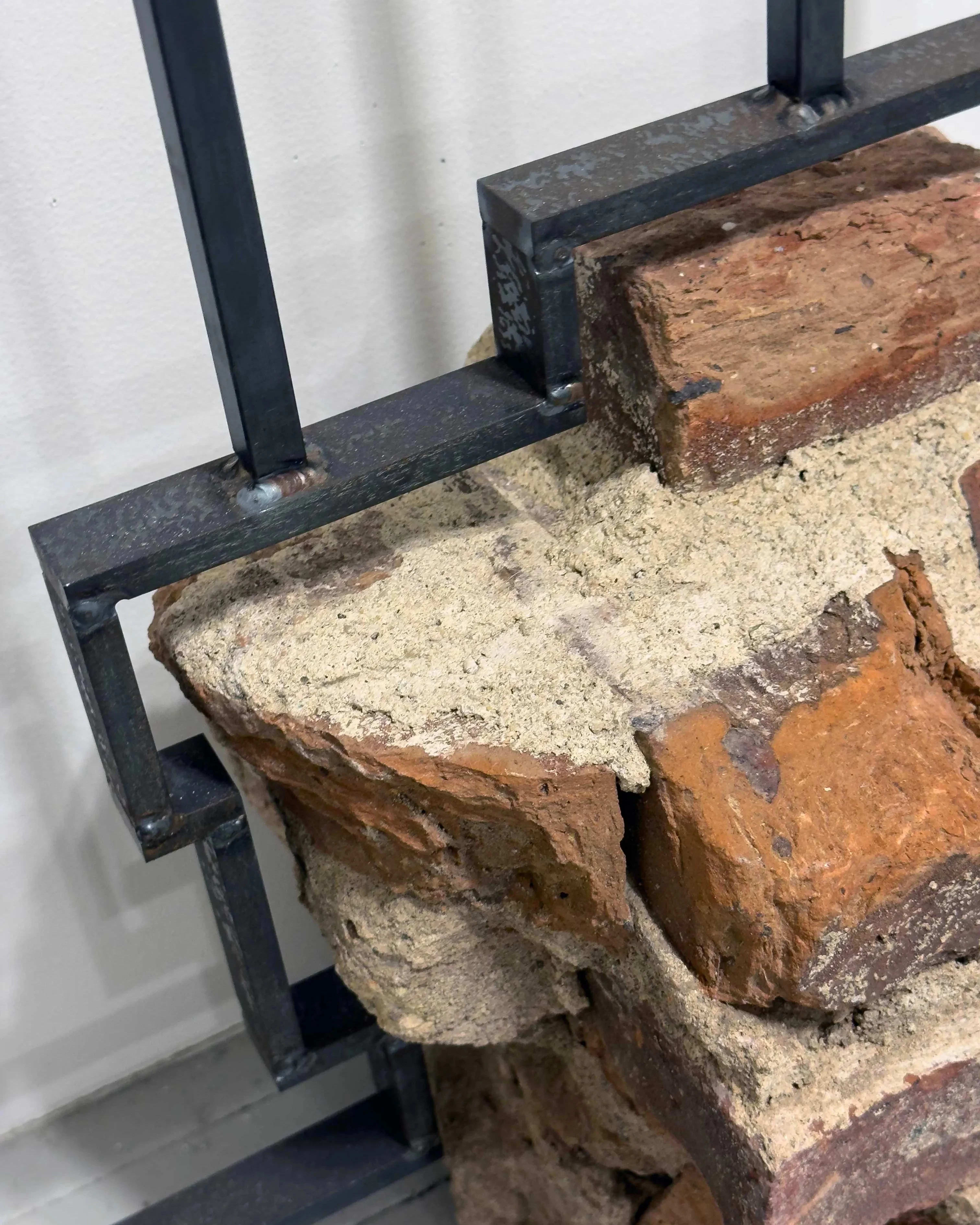 Detail image of a sculpture made of bricks over an iron armature.