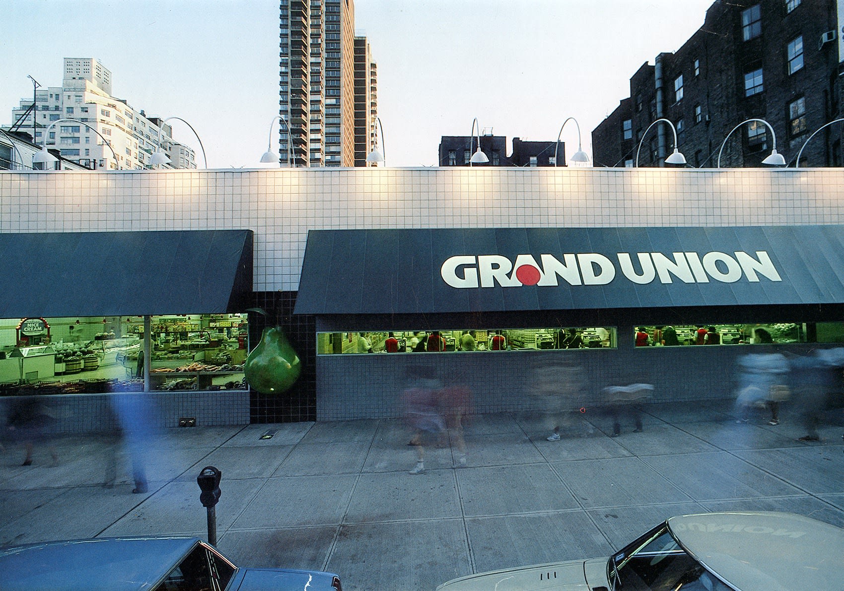 A photograph of the exterior of a Manhattan grocery store in the late 1980s.