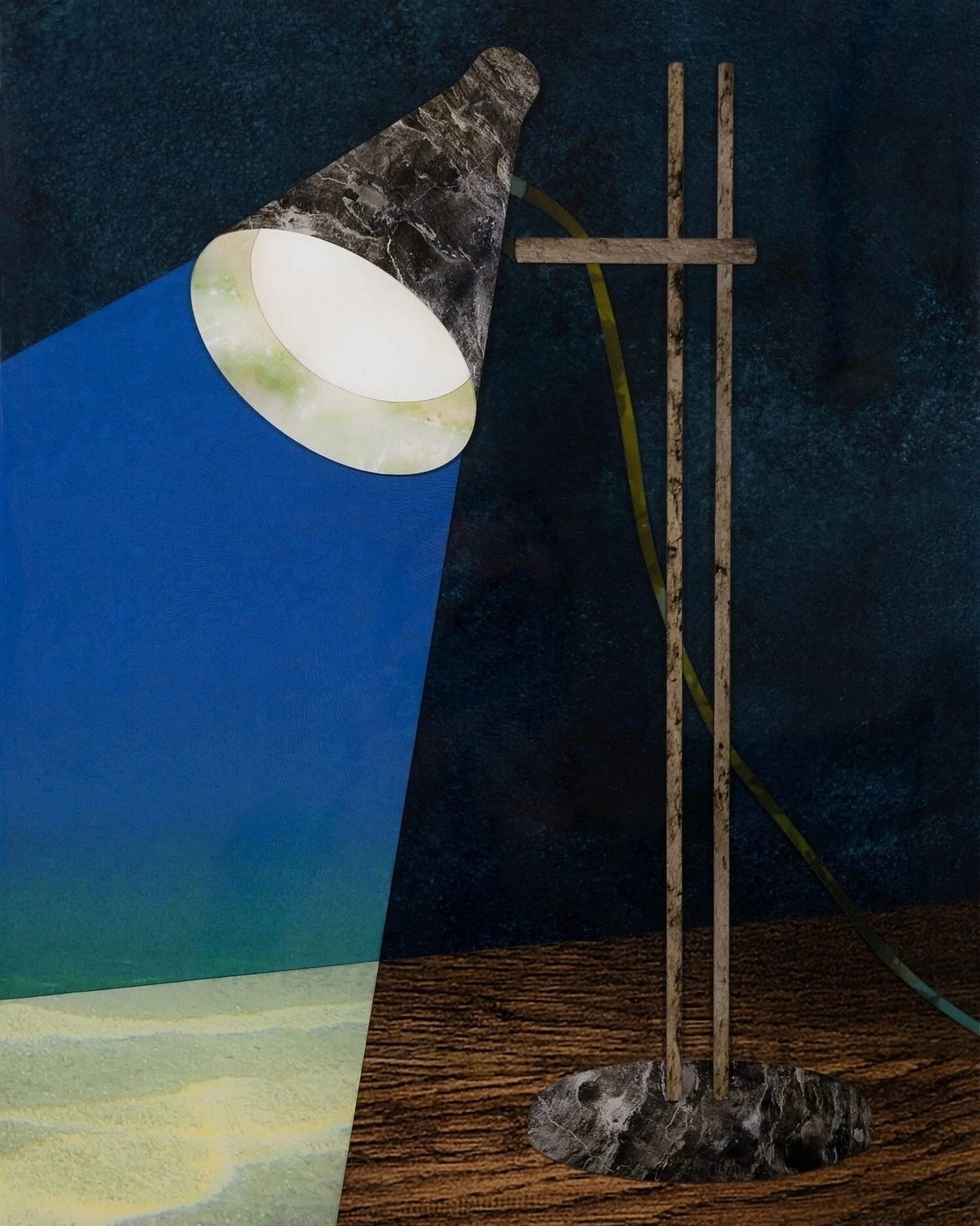 A desk lamp sits on a wooden desktop and shines a light that shows a blue background and a lighter, sand-colored desk.