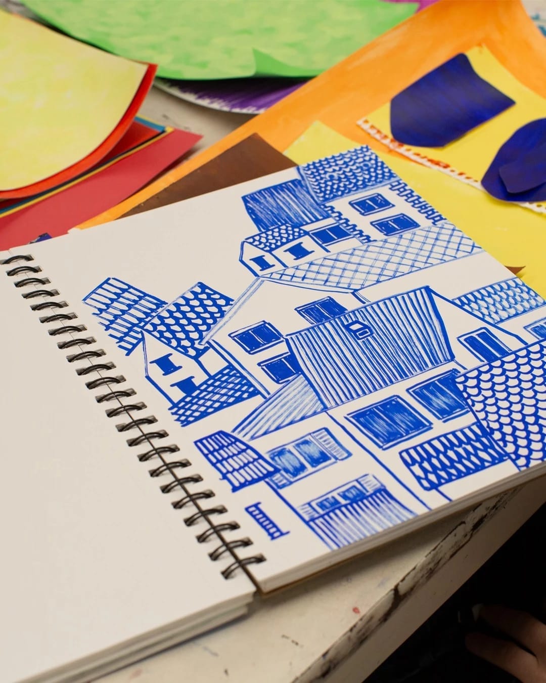 illustration of a cluster of houses in blue pen