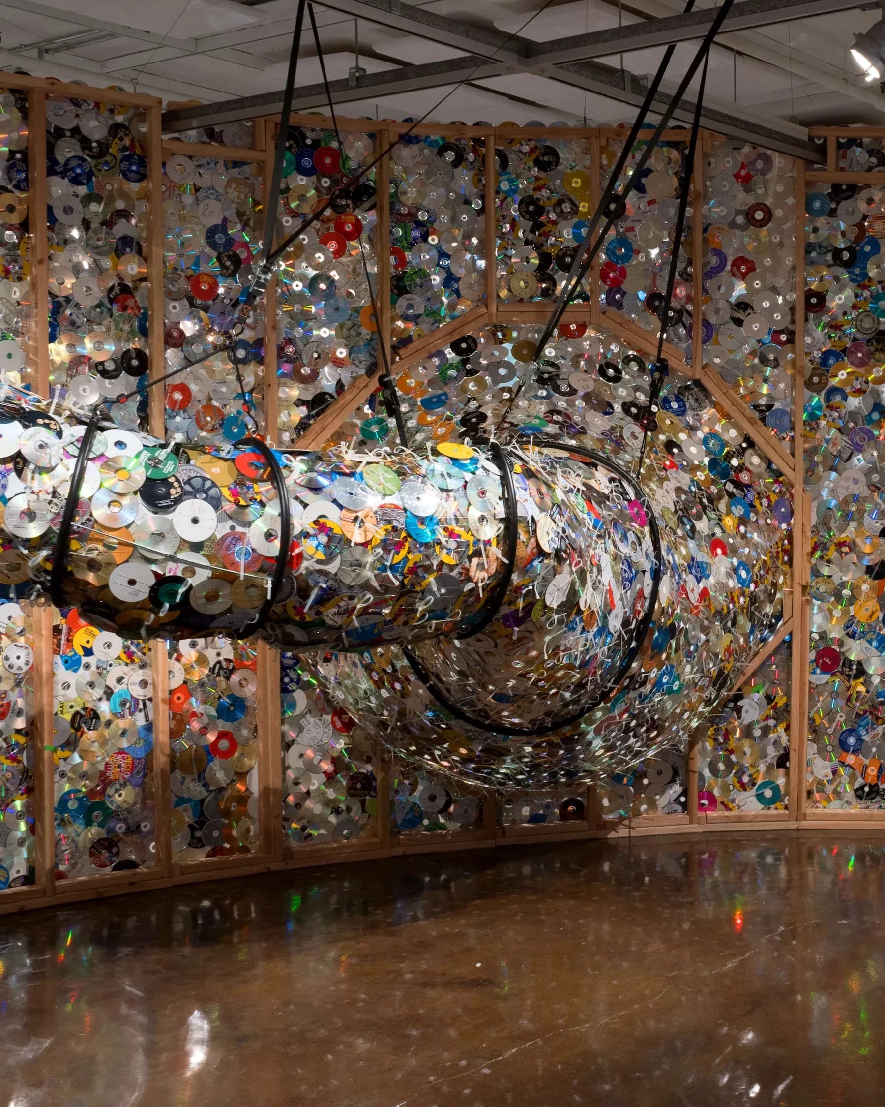 A tunnel emerging from a panel made up of plastic CDs. A 