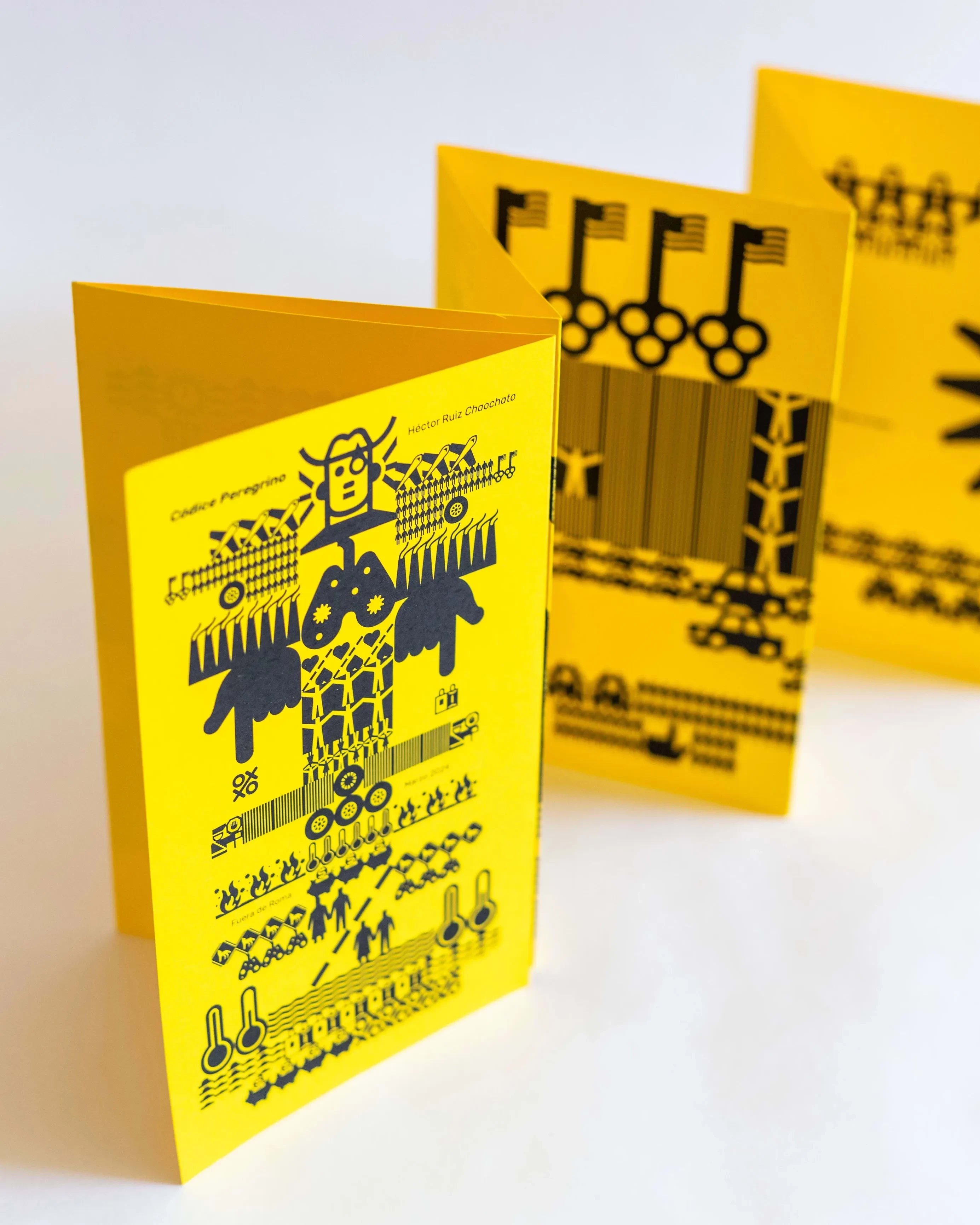 A yellow sheet of paper printed with black symbols like hieroglyphics but with images relating to Mexican heritage and culture.