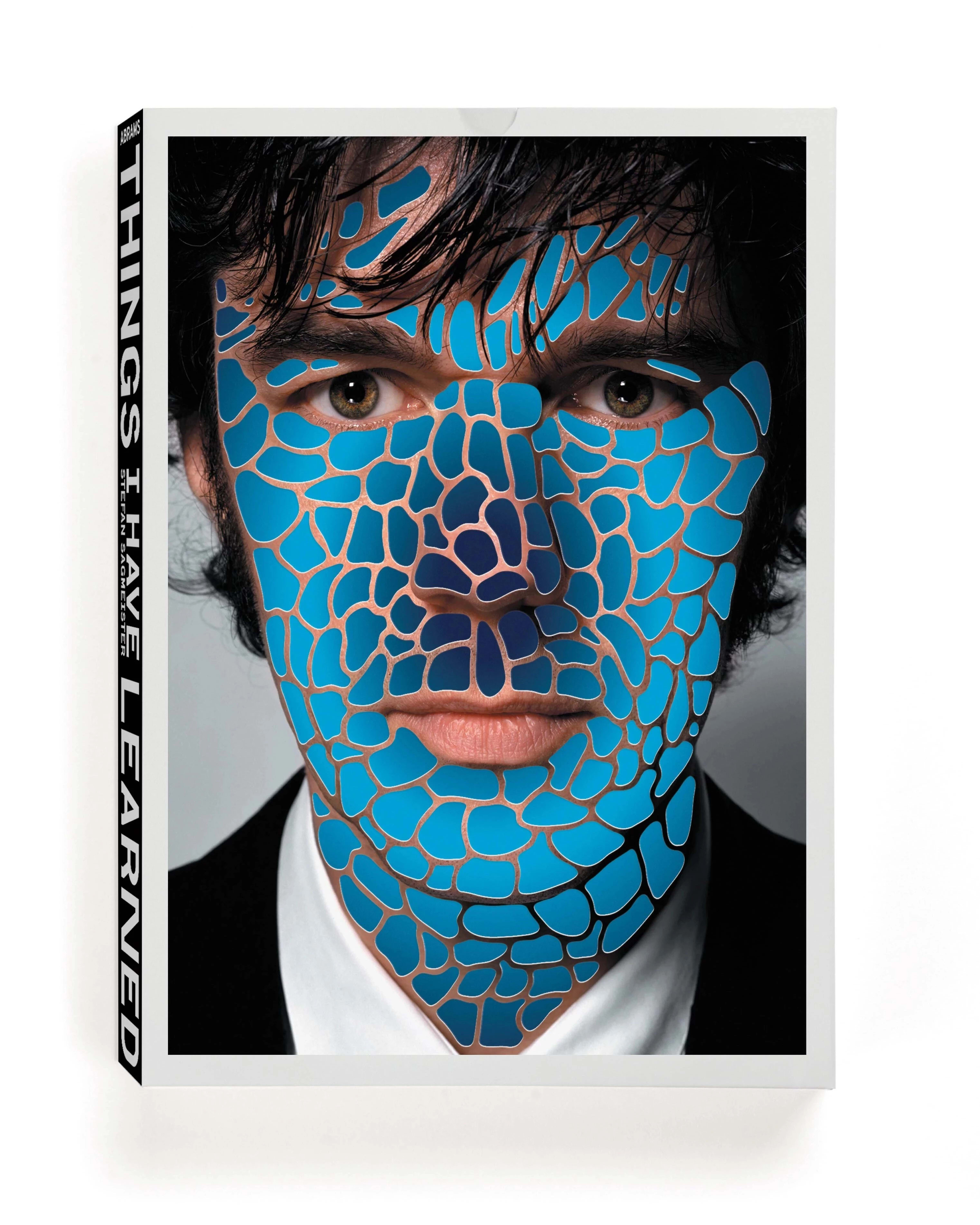Book cover with a photo of Stefan Sagmeister staring at the camera while his skin is covered in cutout oversized cell-like shapes, revealing a circular gradient beneath.