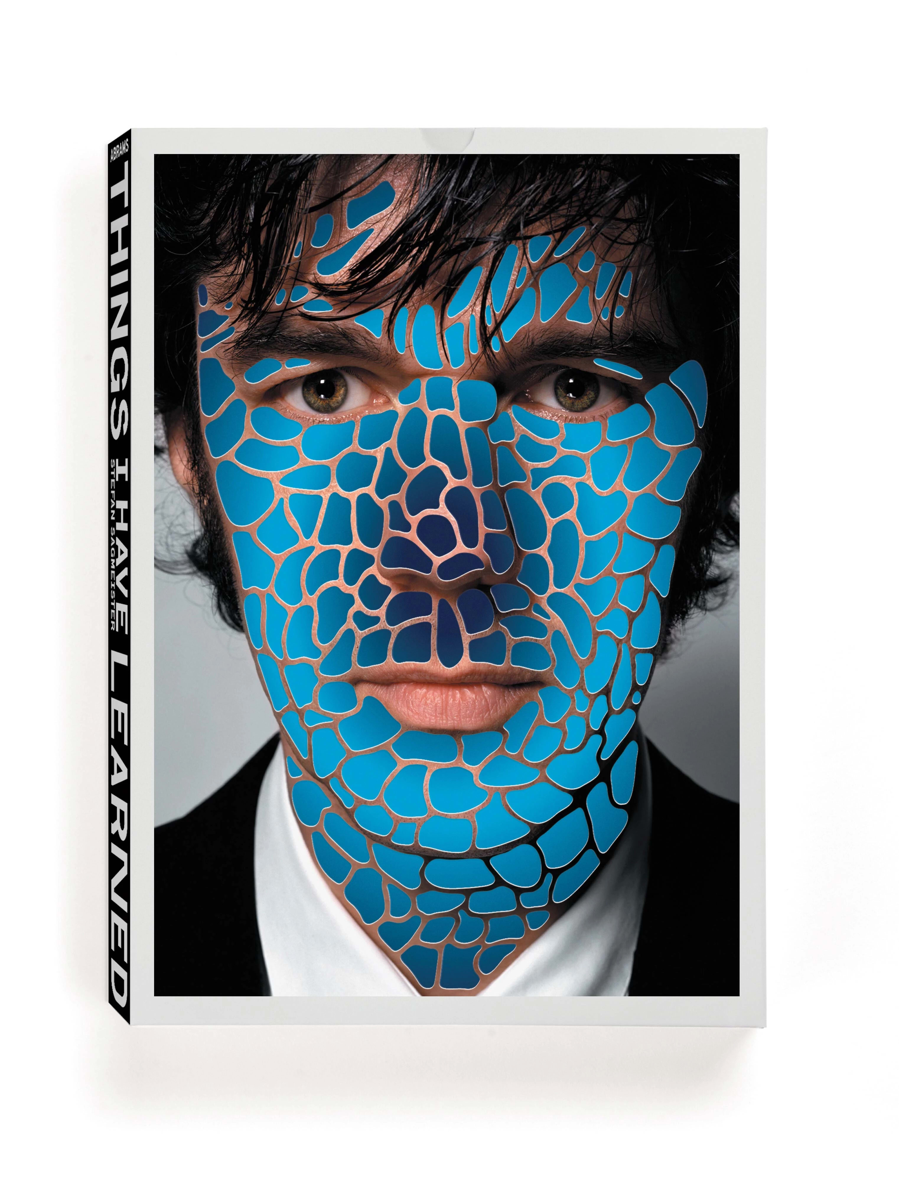 Book cover with a photo of Stefan Sagmeister staring at the camera while his skin is covered in cutout oversized cell-like shapes, revealing a circular gradient beneath.