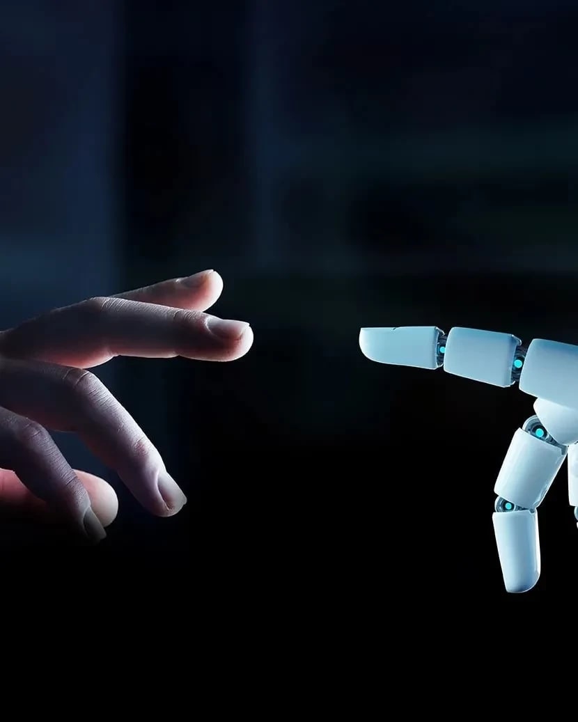 Human hand and robot hand reaching towards one another