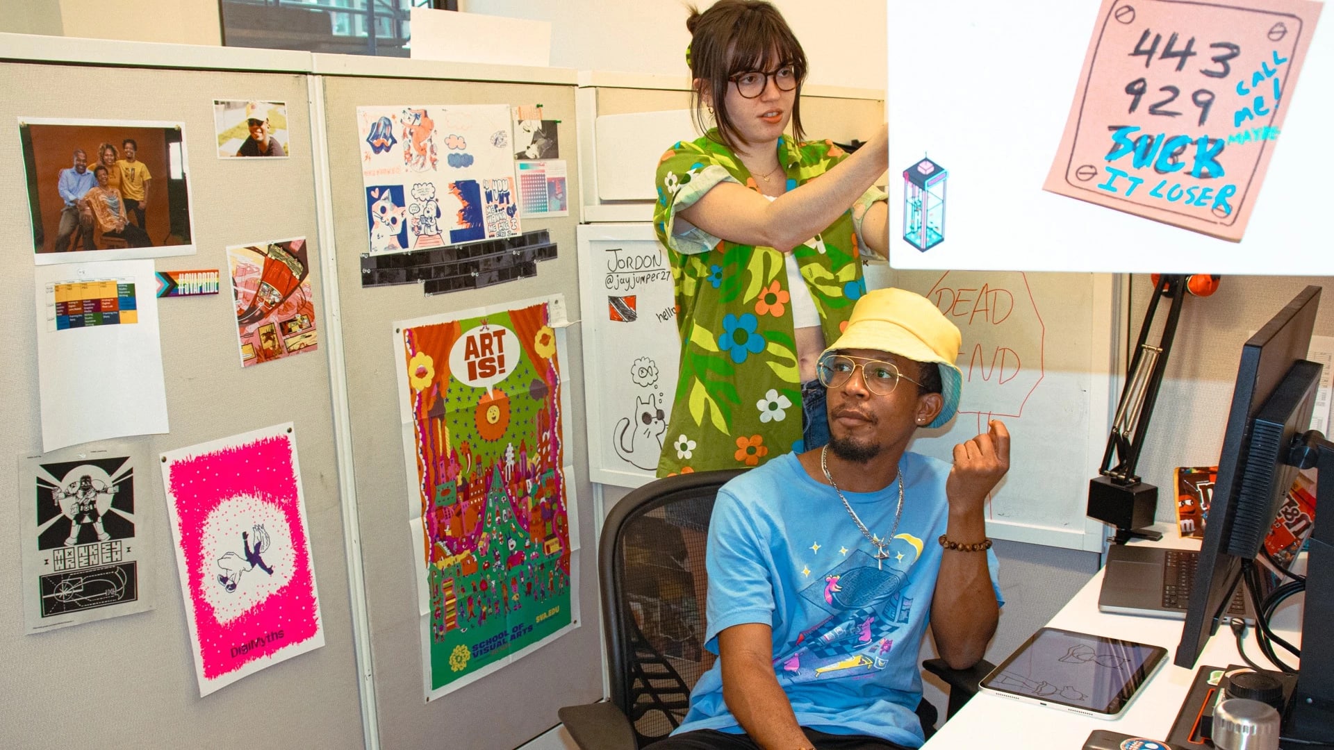 Two students in their studio workspaces.
