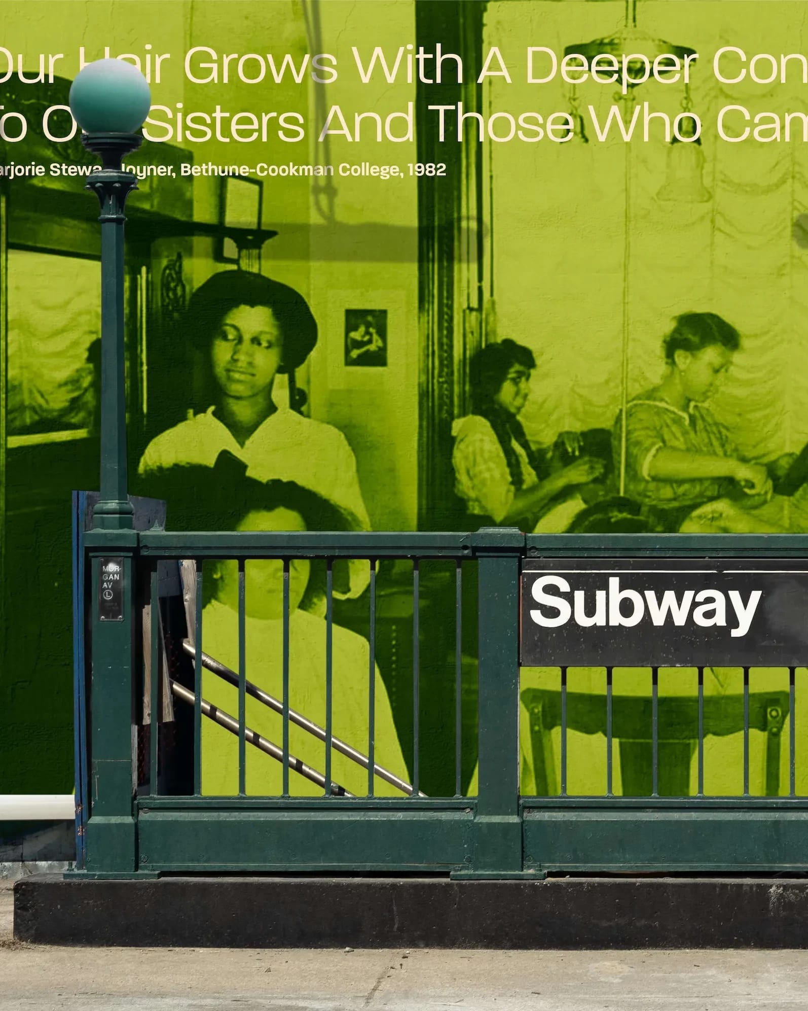 A subway station stairway with a bright green billboard in the background depicting black women caring for their hair. 