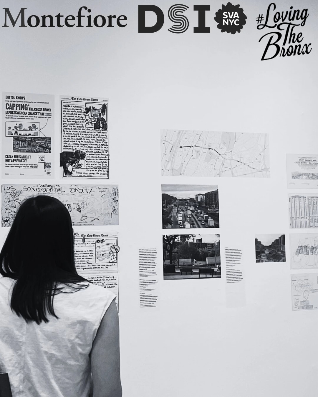 Black and white photo in art gallery with multiple pieces of work on wall and 2 silhouettes on the left side looking at the work. Logos of Montefiore, SVA DSI, #Loving the Bronx, in top right